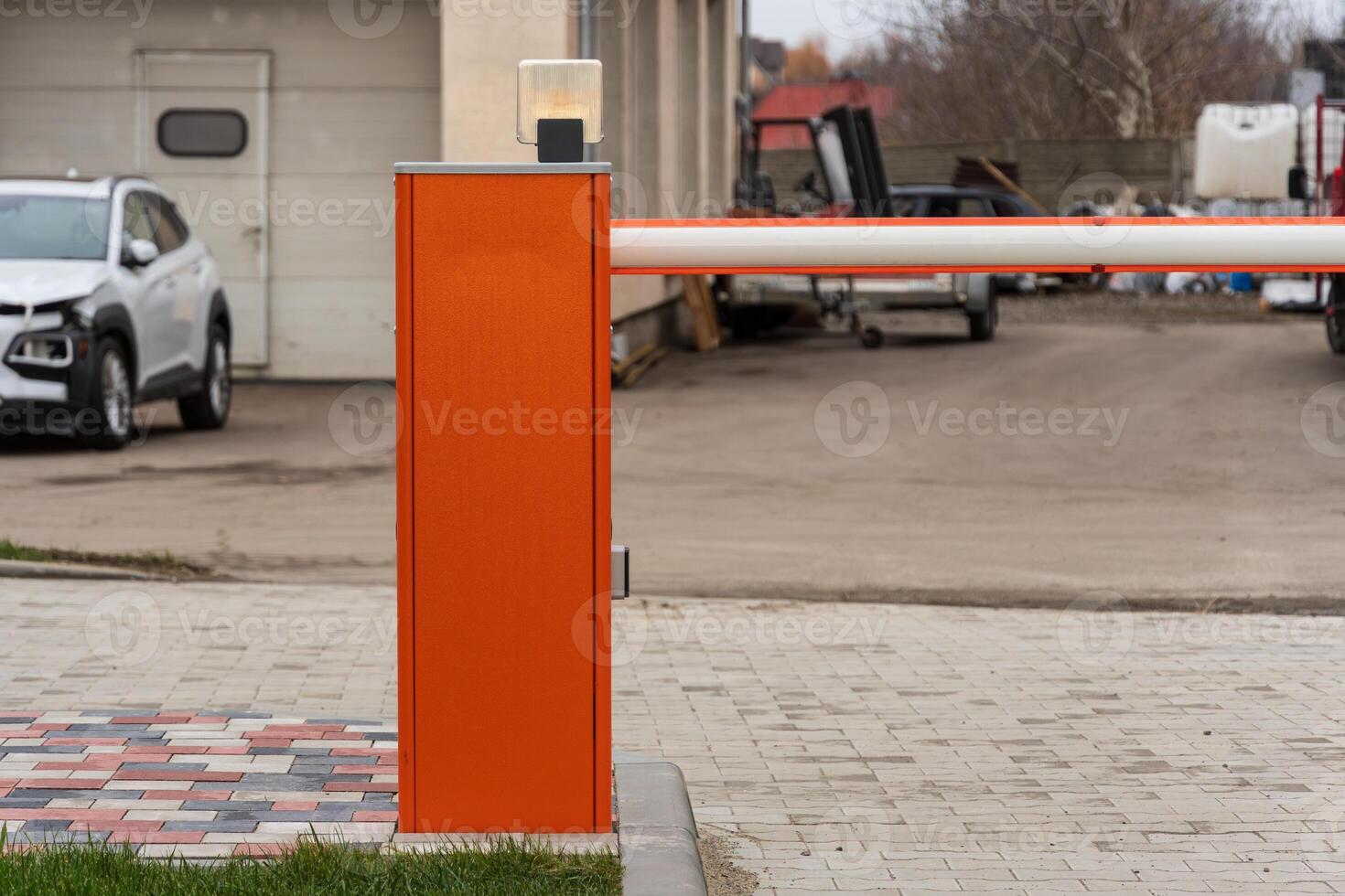 Closed security barrier at parking lot entrance restricts vehicle access and enhances safety for authorized entry only photo