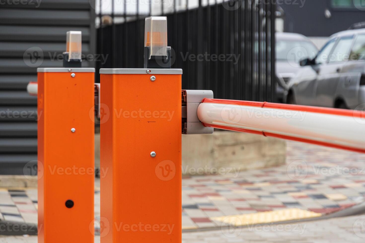 A closed security barrier stands at the entrance of a parking lot, regulating vehicle access while ensuring safety and control photo