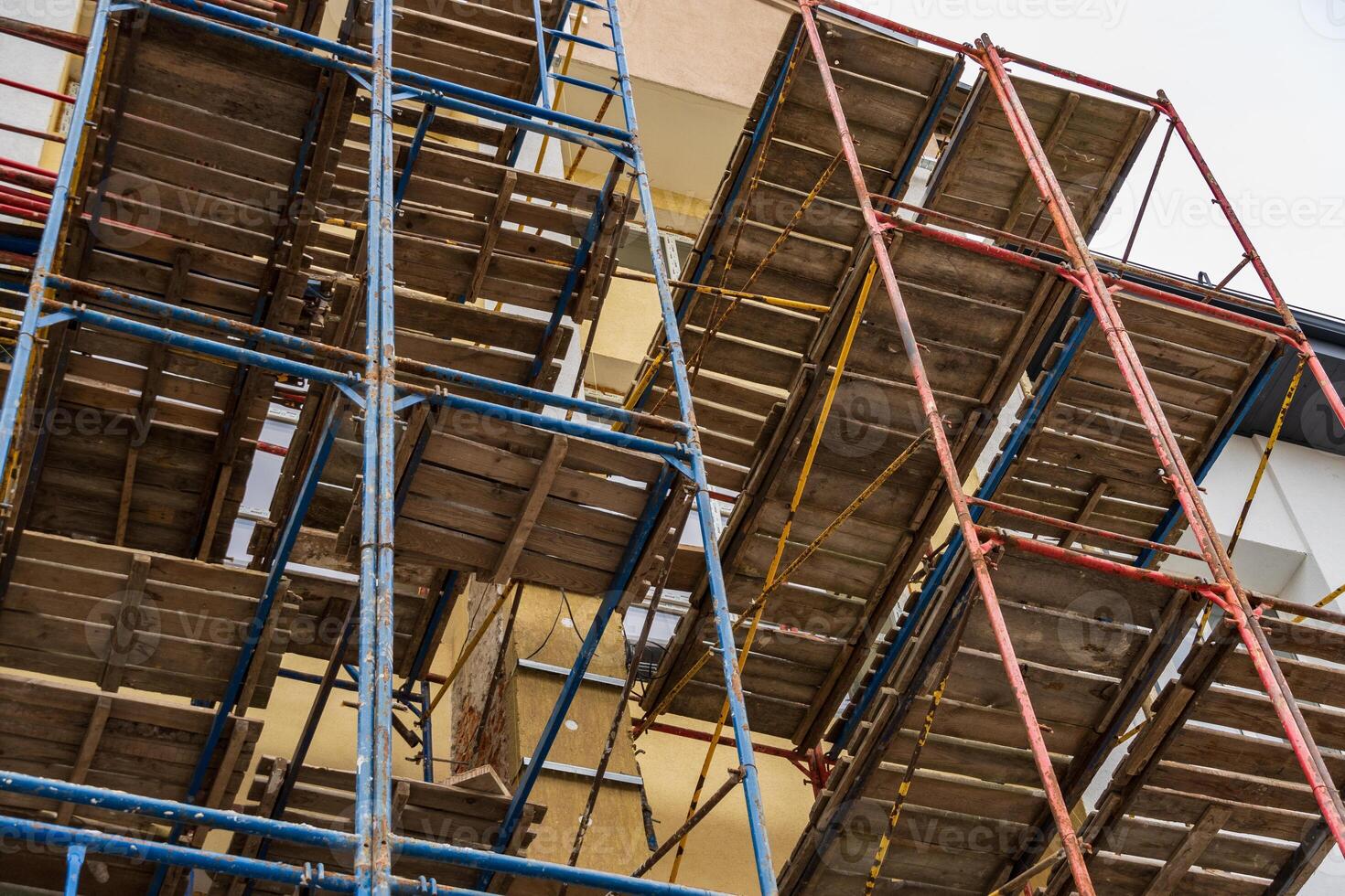 Workers utilize scaffolding systems for safe access during the construction of a multi-story building, showcasing industry activity photo