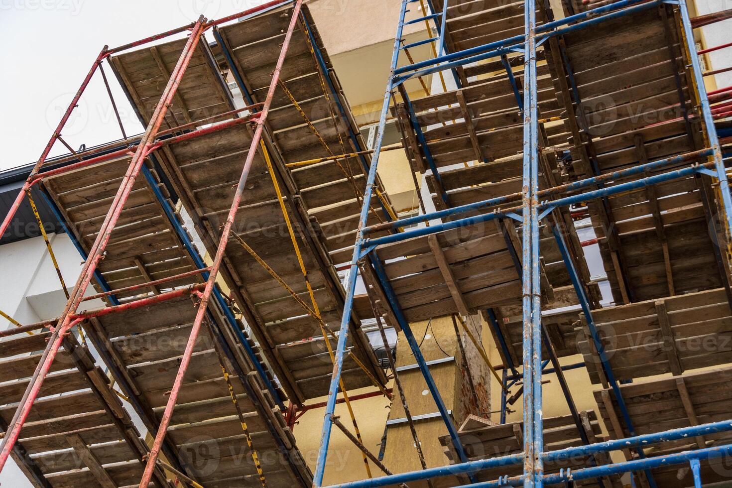 Workers rely on sturdy scaffolding to safely navigate and complete building projects at a construction site in progress photo