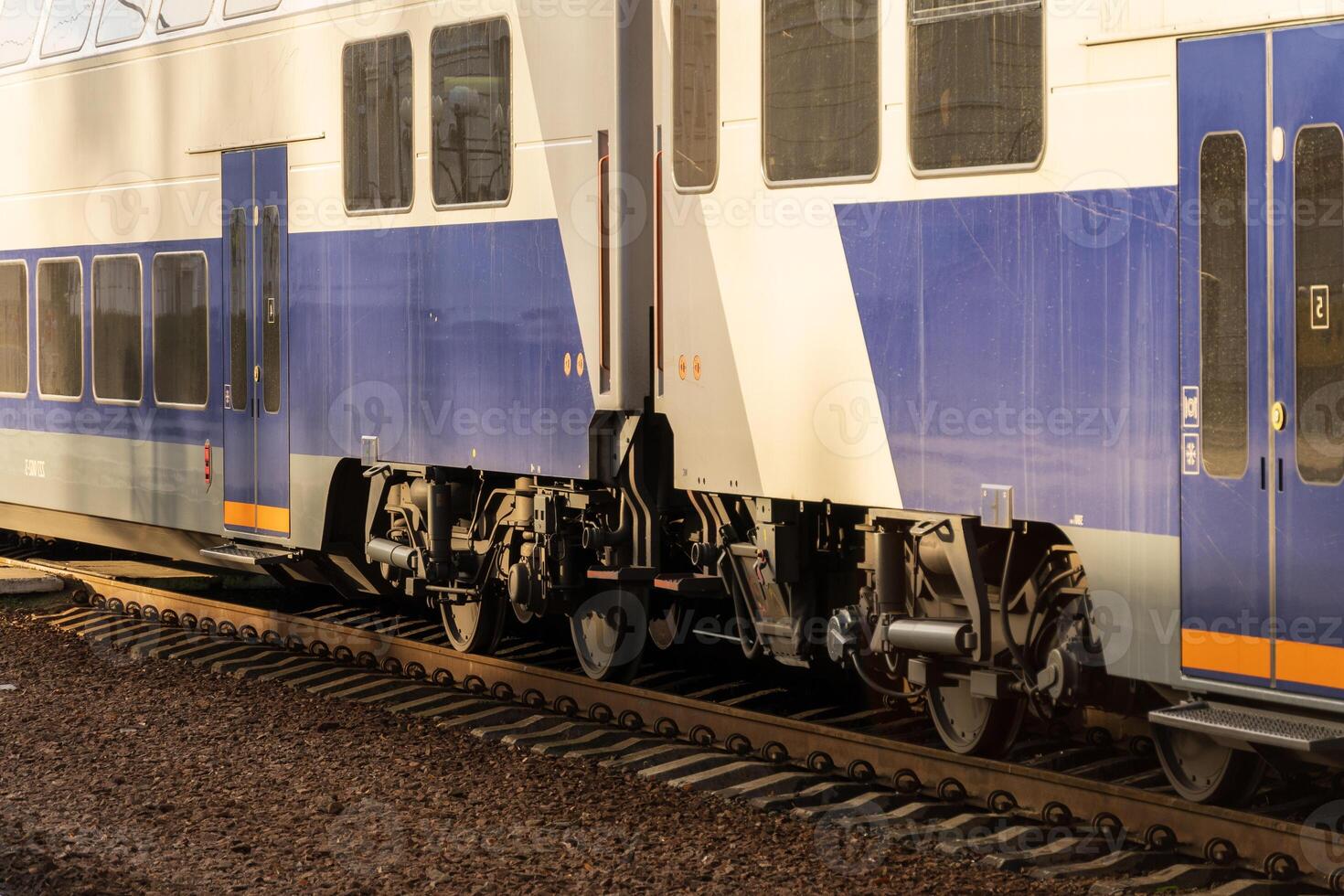 A sleek electric train stands on the railway platform, highlighting its modern features and industrial design during daylight photo