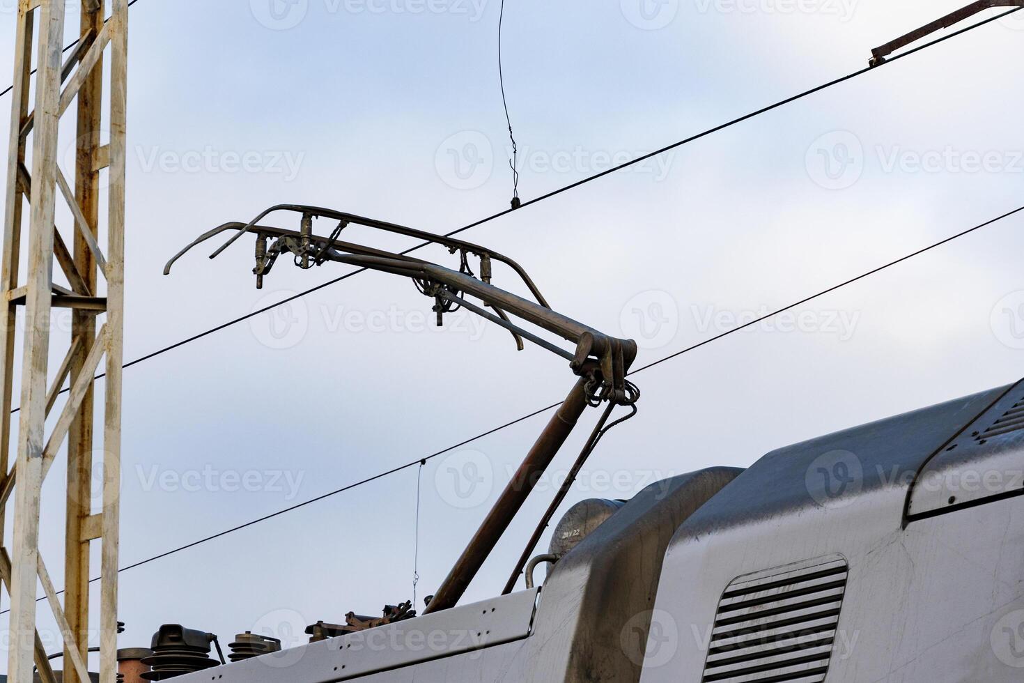 The overhead conductor of a modern electric train stretches above the railway, ready for transportation operations at the station photo