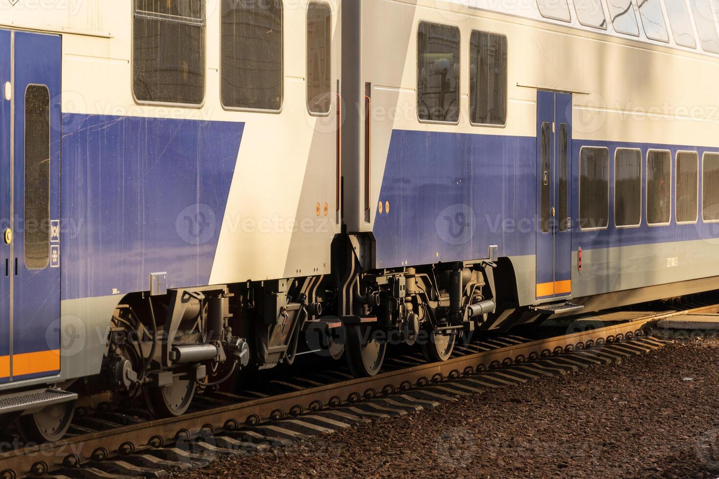 A sleek electric locomotive arrives at the platform, ready to transport passengers at a busy modern railway station in the afternoon light photo