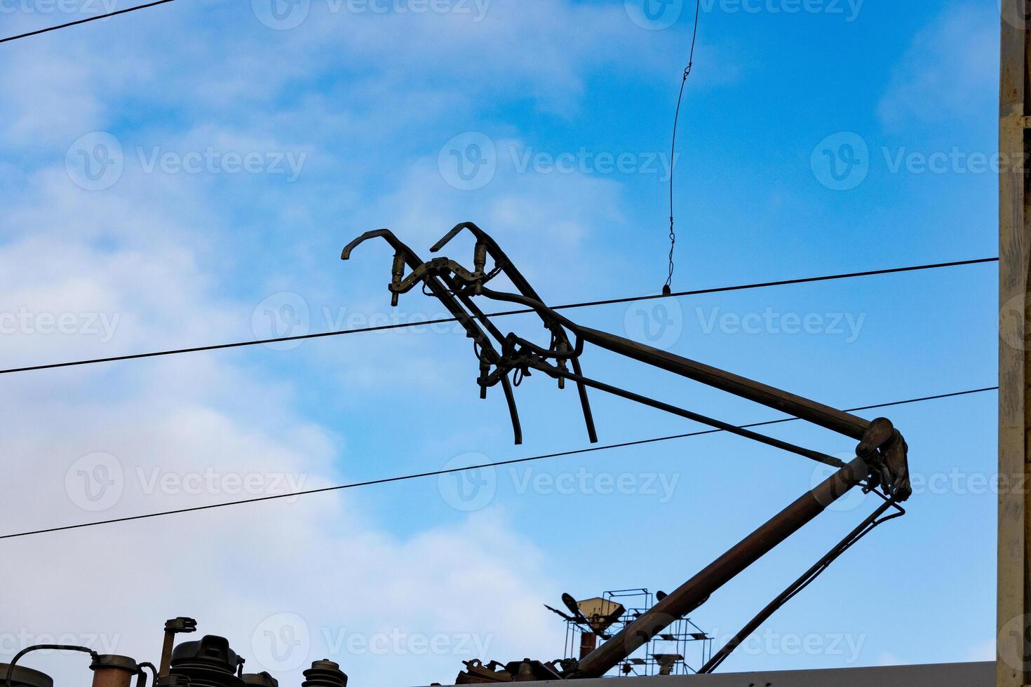 Electric train overhead lines stretch across the sky, showcasing modern transportation technology in a railway station setting photo