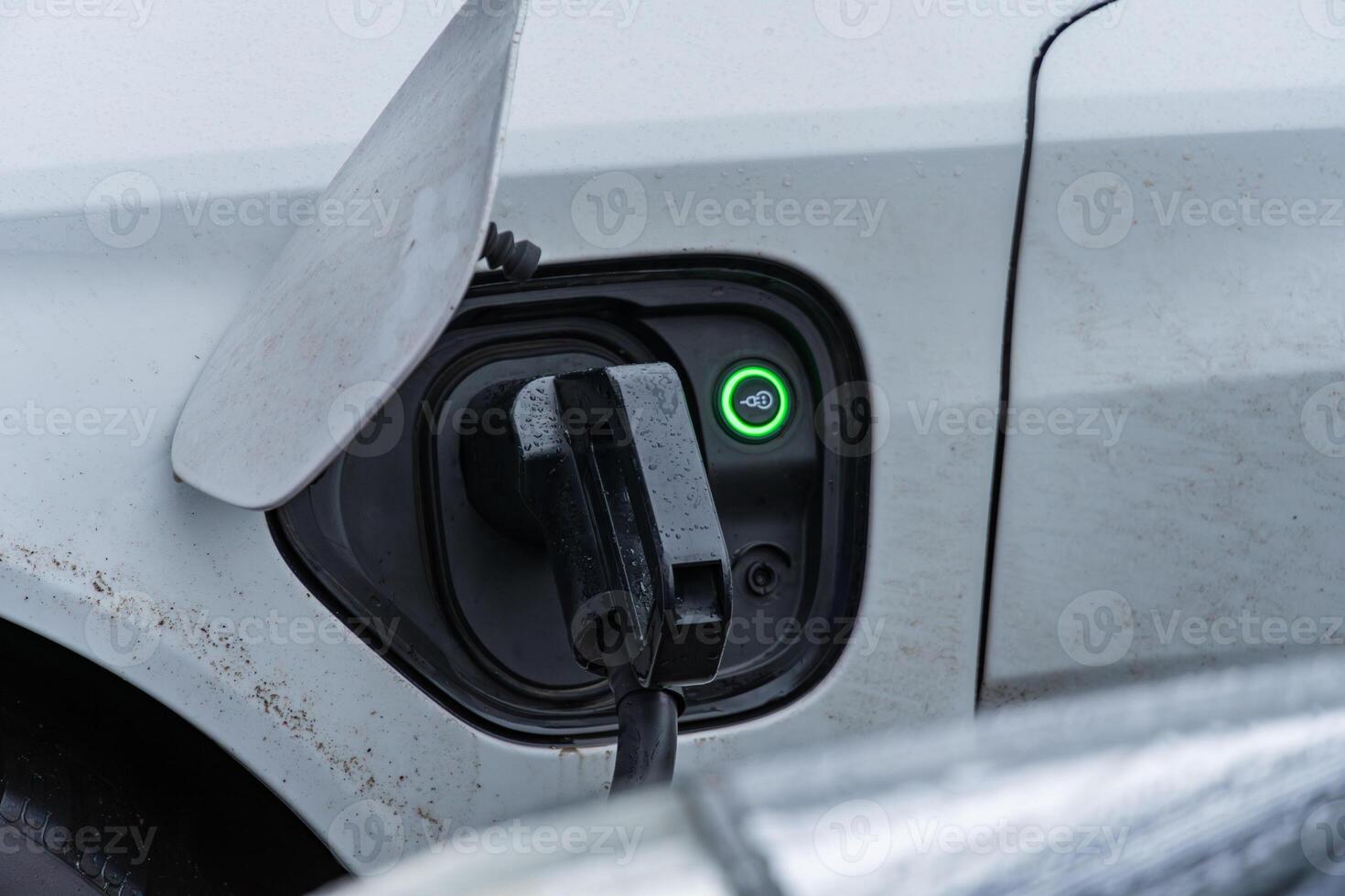Electric car connected to a charging station, showcasing the transition to renewable energy and the growth of sustainable vehicles photo