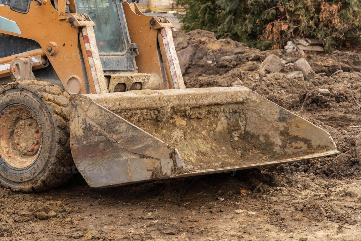 Backhoe operates at a construction site, efficiently digging and preparing the ground for new infrastructure development and engineering tasks photo