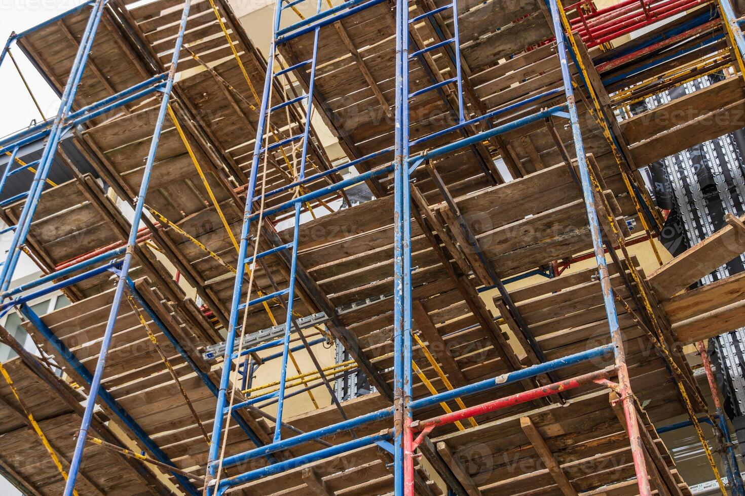 Multiple levels of scaffolding are used to support construction work, ensuring a safe environment for workers and efficient project progress photo