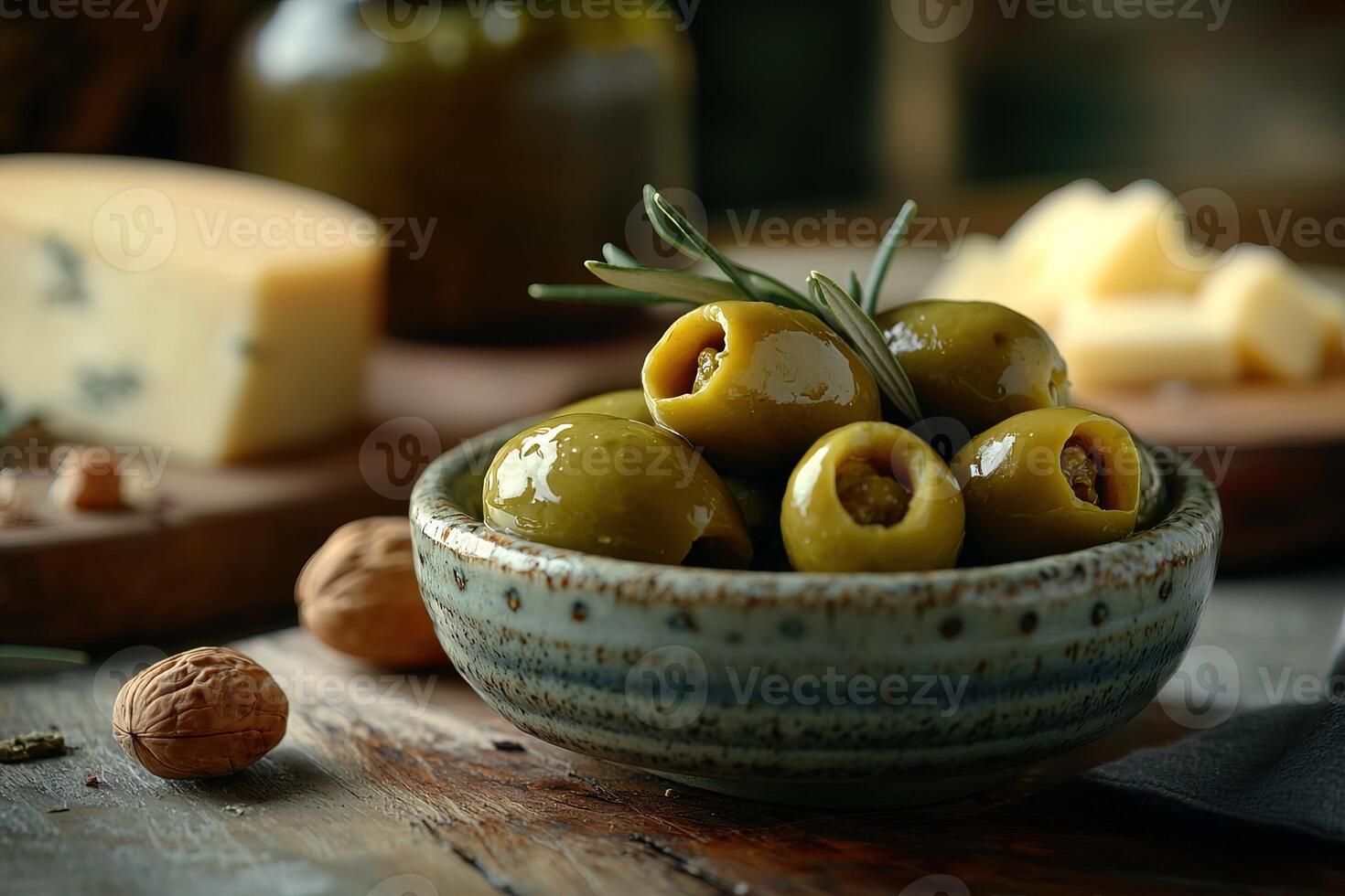 Gourmet olive plate with pimento stuffed green olives, complemented by rustic cheese wedges and crunchy nuts, perfect for appetizers or wine pairing photo