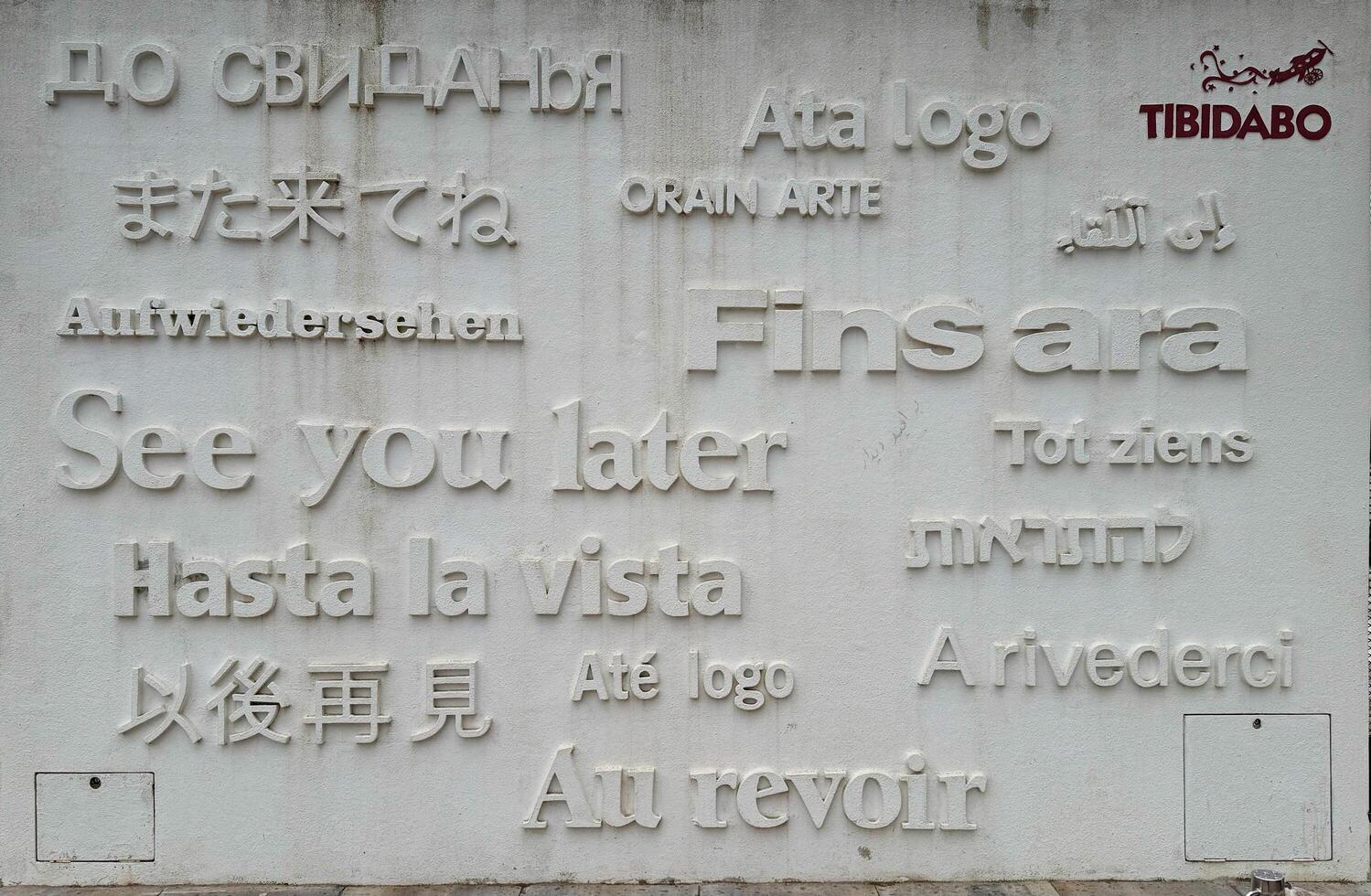 Barcelona, Spain - March 26, 2025. Tibidabo. Multilingual farewell wall art featuring various languages at Tibidabo amusement park in Barcelona photo
