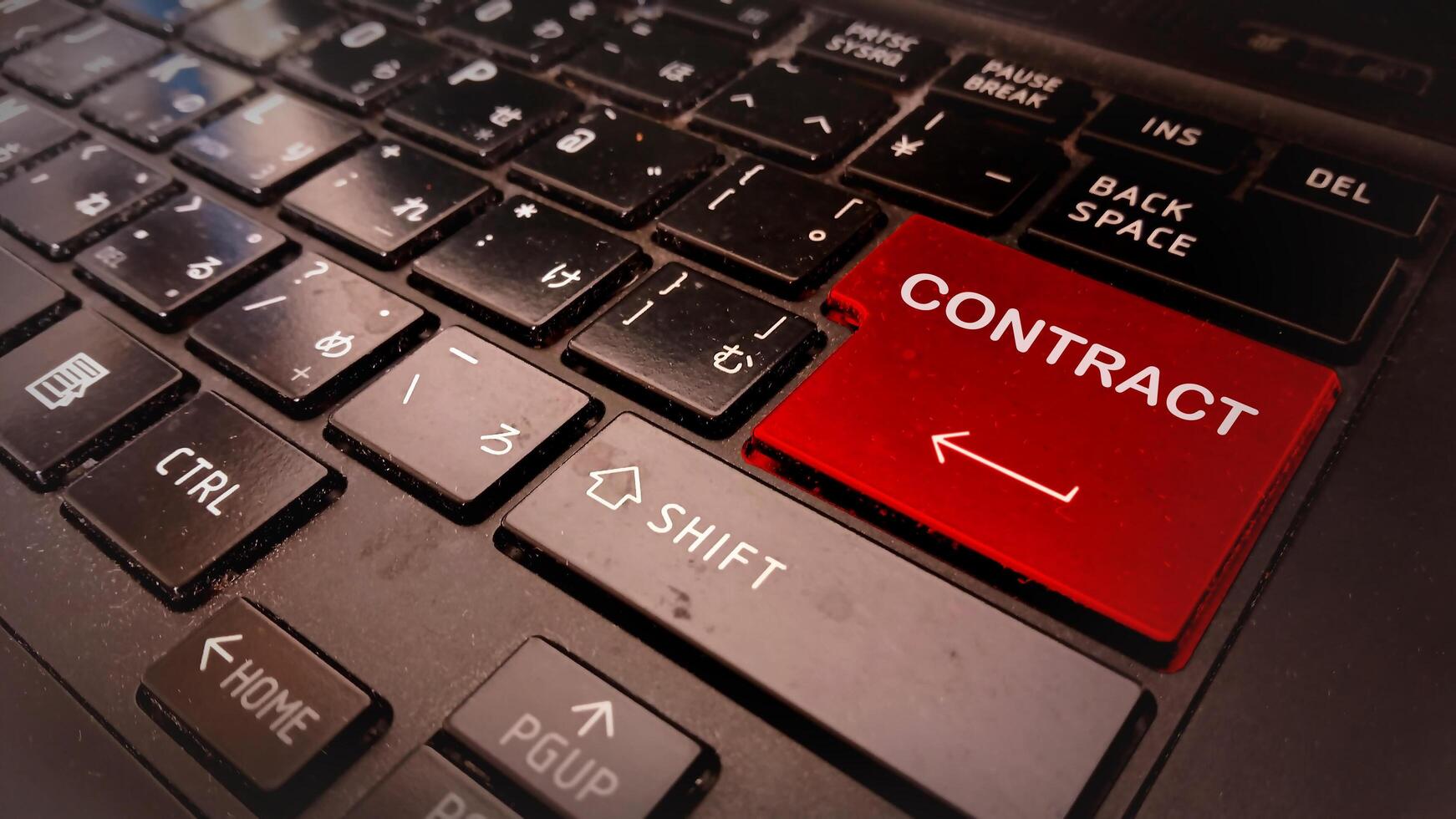 A red contract button on a laptop keyboard photo
