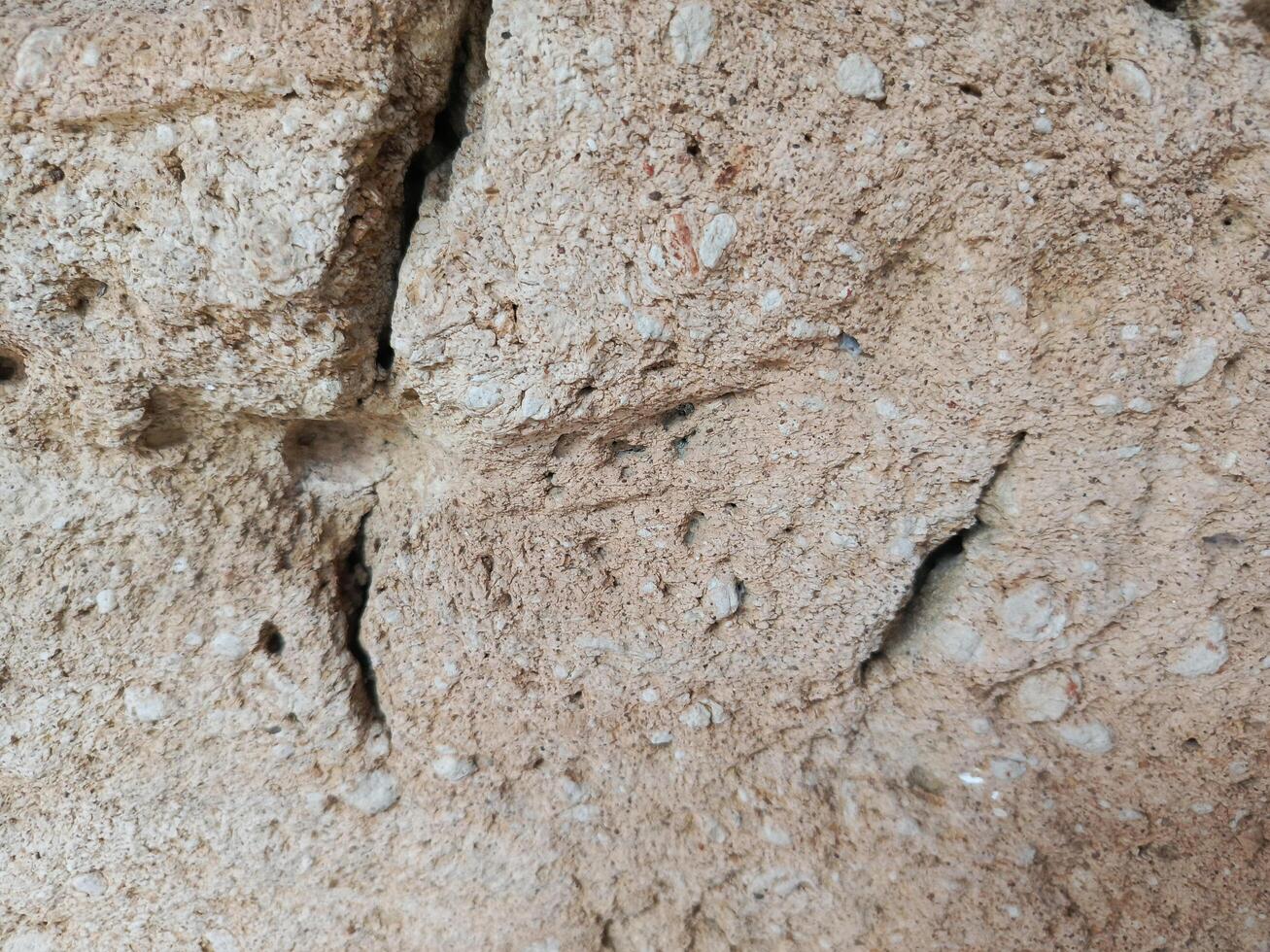 Rough Beige Stone Texture with Cracks, Close Up photo