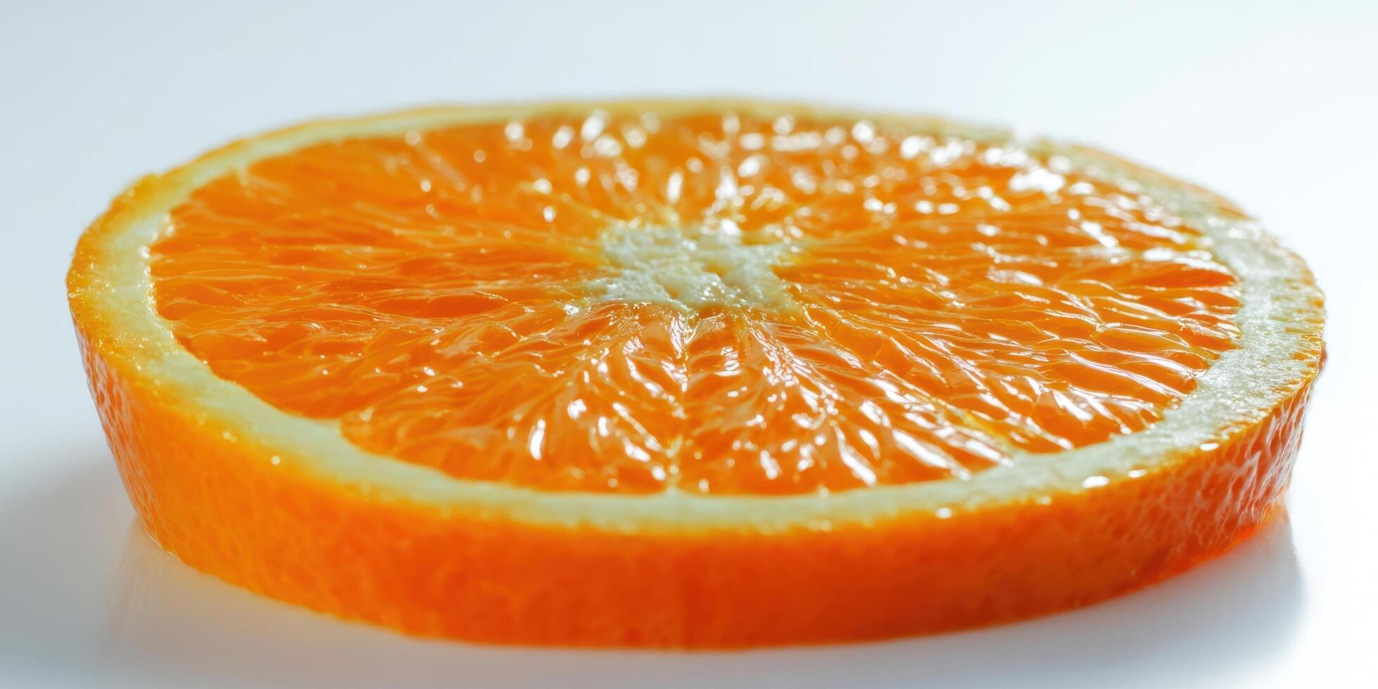 The close-up view of a vibrant orange fruit slice on a white background. photo