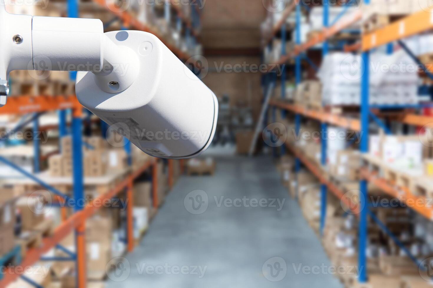 surveillance at an industrial enterprise. The camera captures what is happening in the room around the clock. Installation of a surveillance system in a warehouse. photo