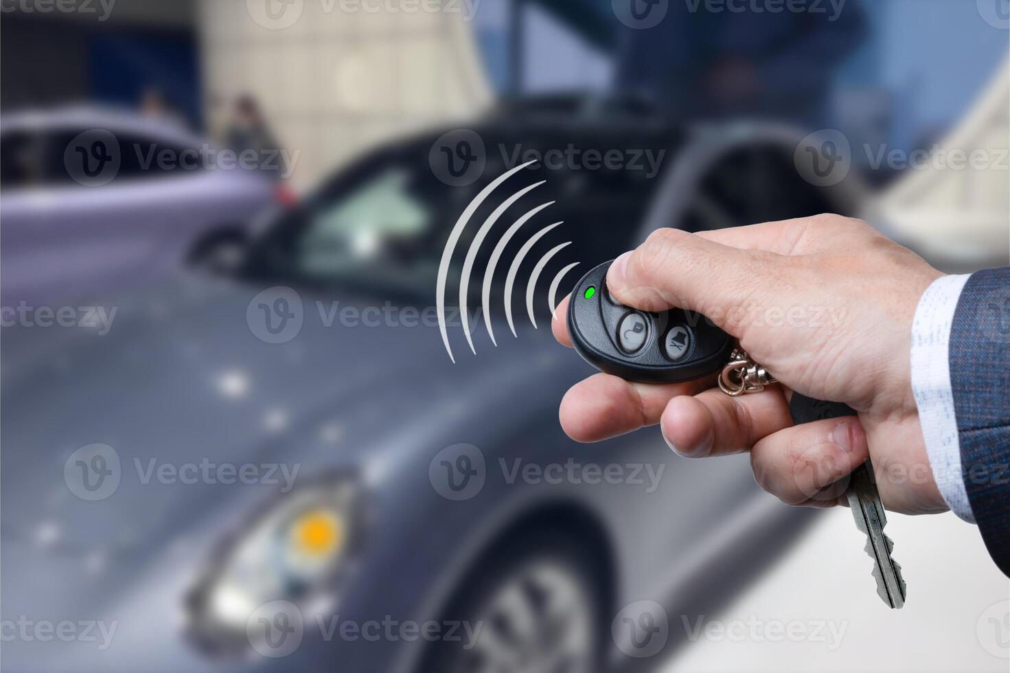 Men's hand presses on the remote control car alarm systems. photo