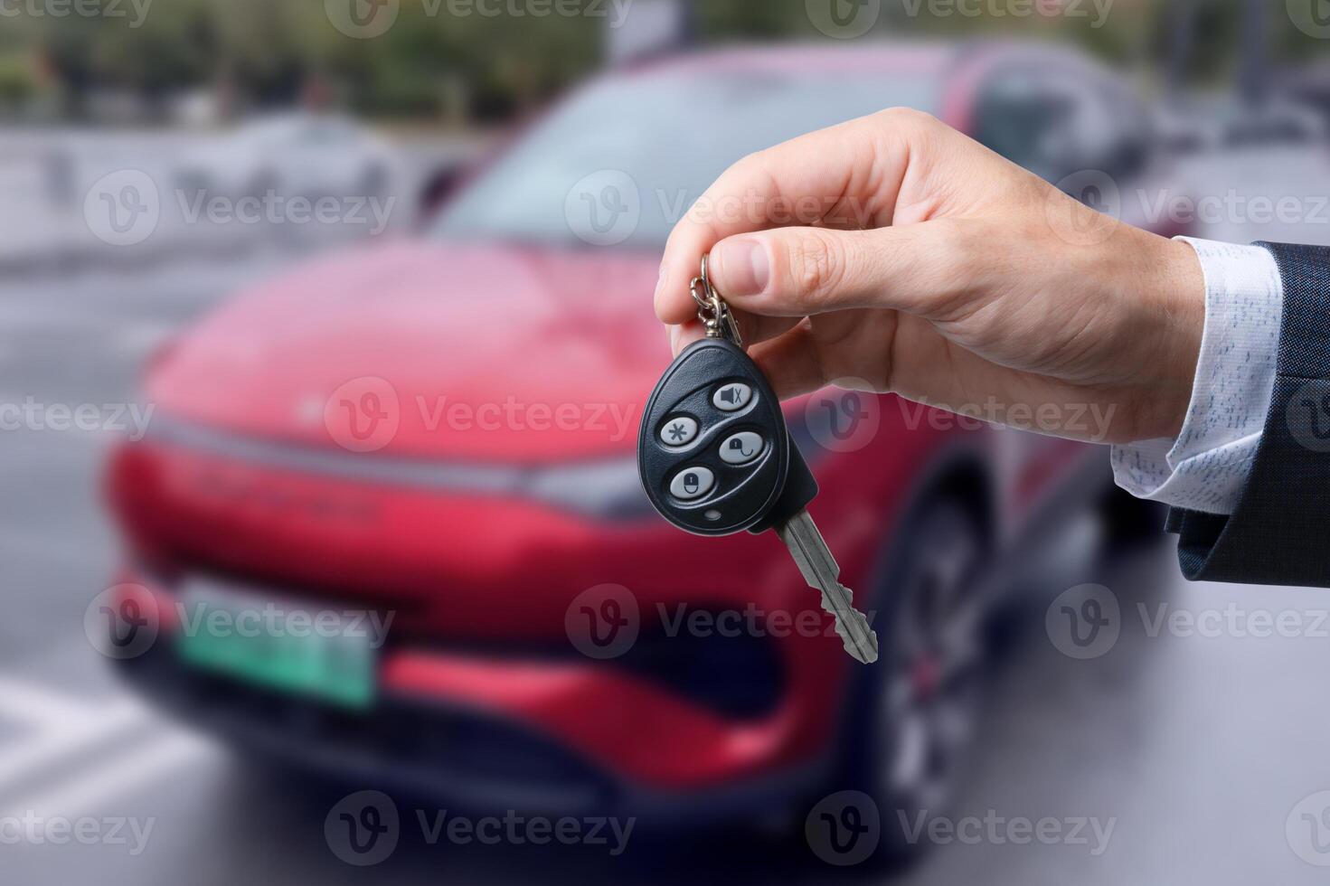 Close-up of dealer handing keys to new owners at a car show Automotive business Car sales Agreement Concept Men car salesman handing over new car keys photo