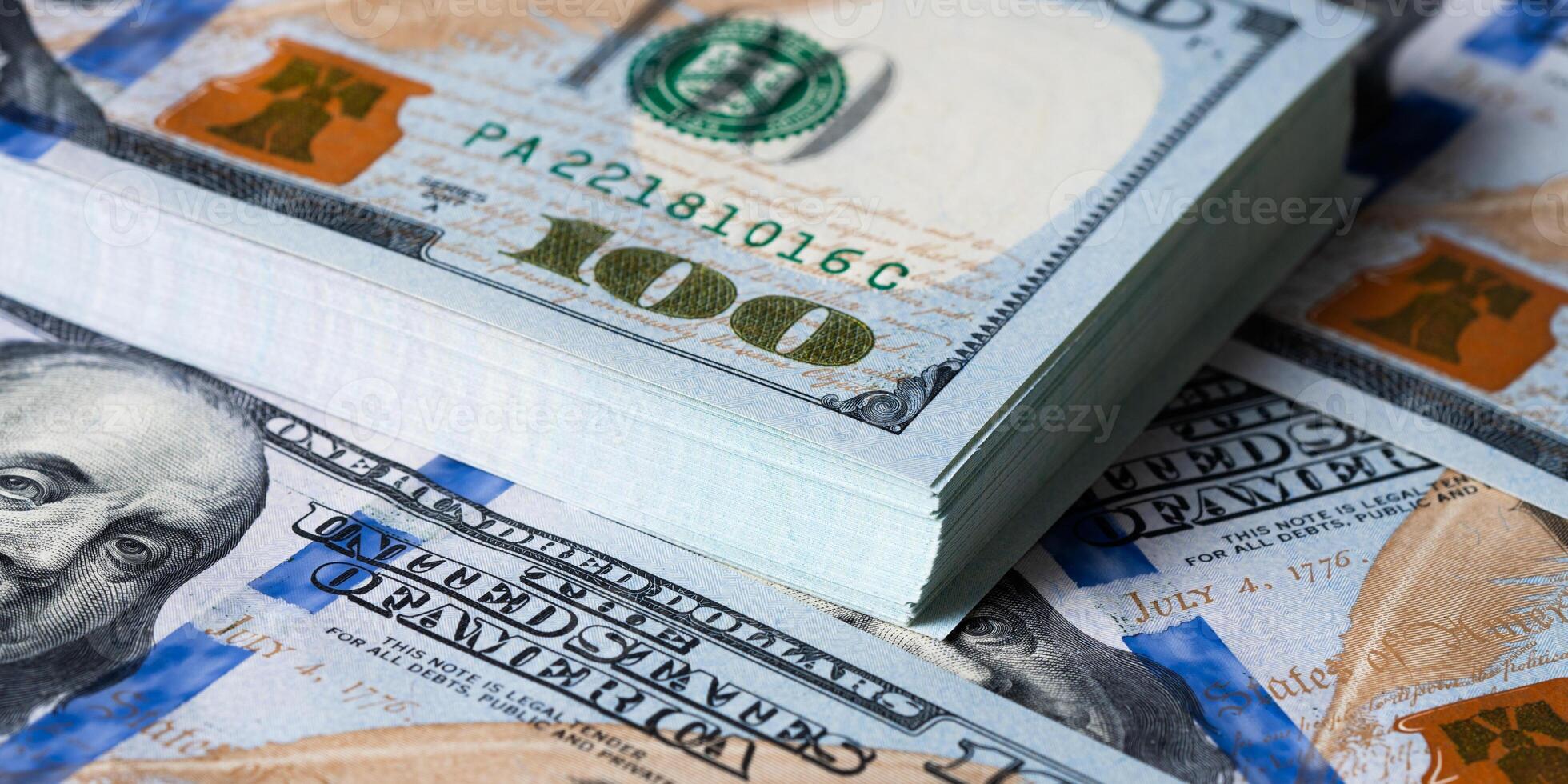 A bundle and a roll of dollars on bills of one hundred dollars. photo