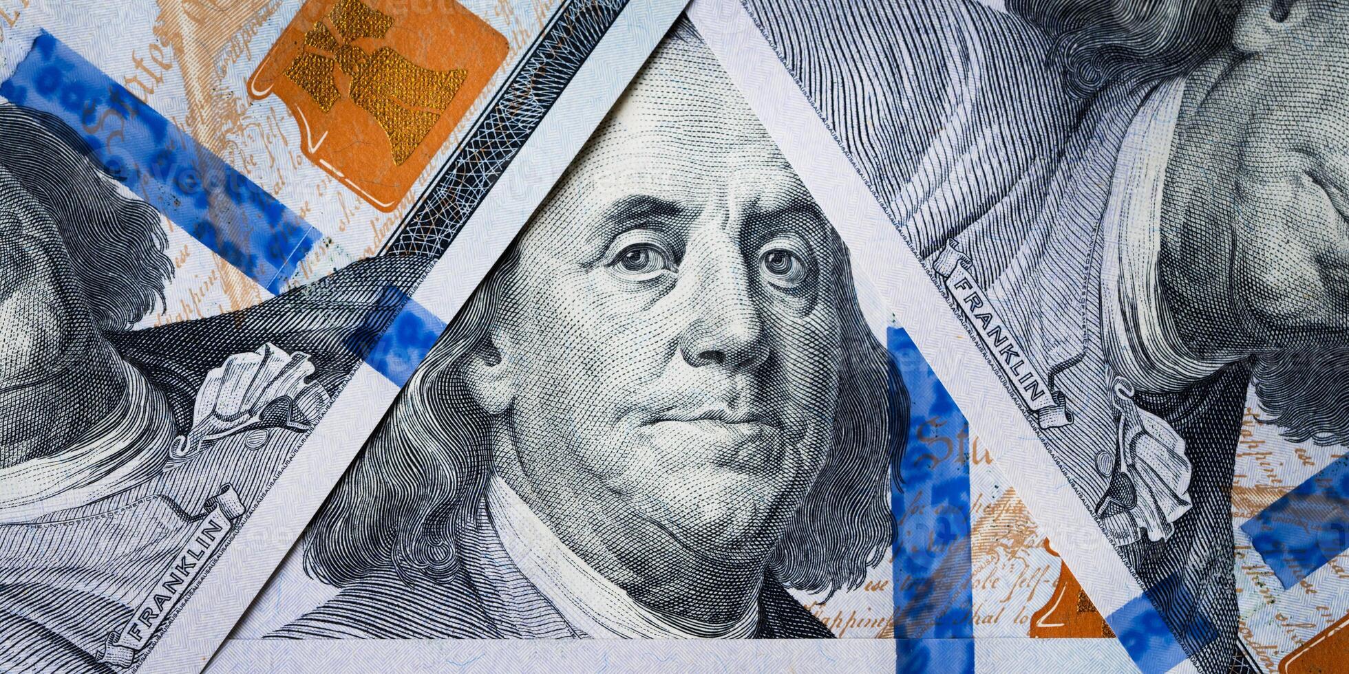 Dolar USA close up. Benjamin Franklin's eyes from a hundred-dollar bill . The texture of the fragment of the dollar bill. One hundred American dollars. photo
