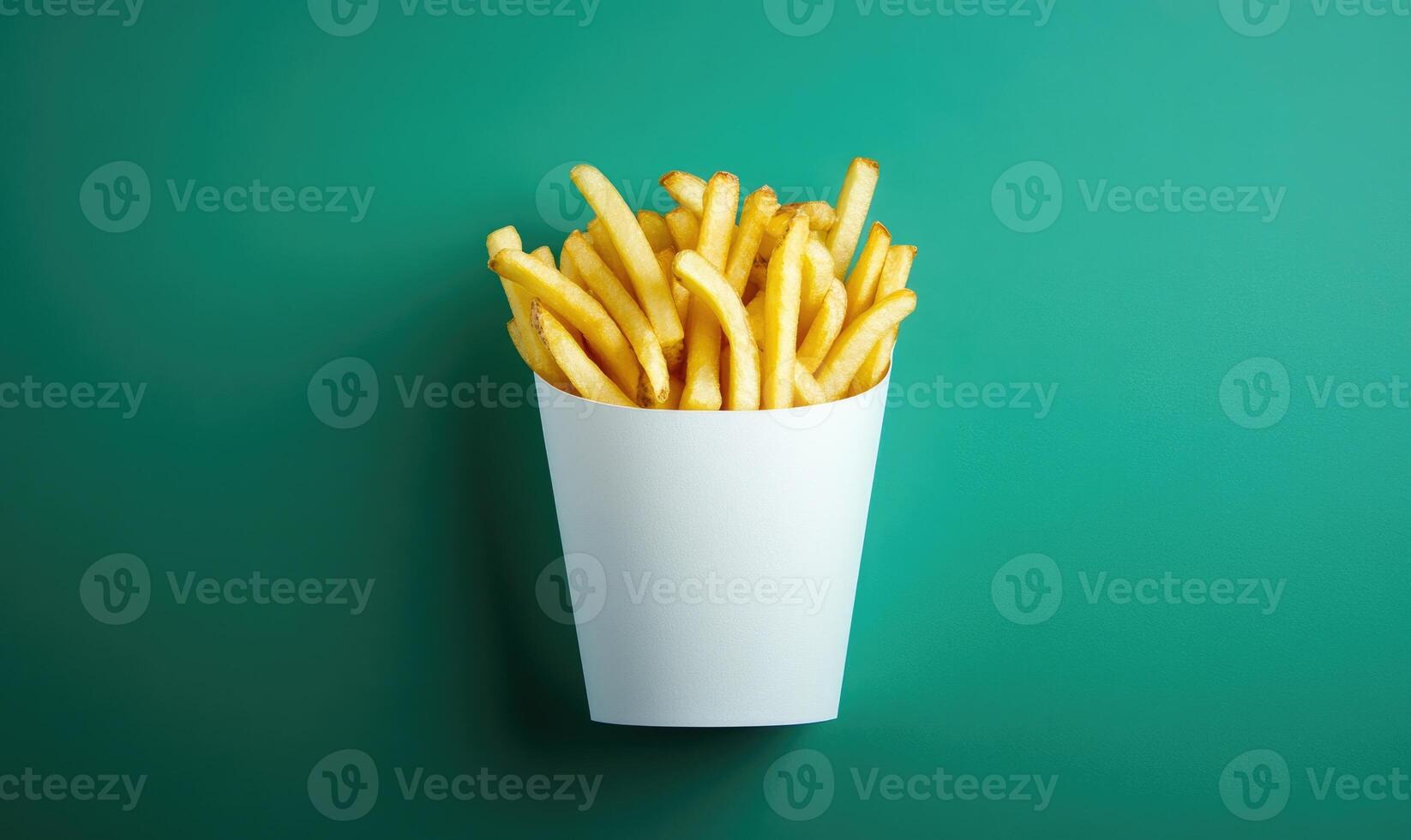 A white paper cup with french fries inside photo