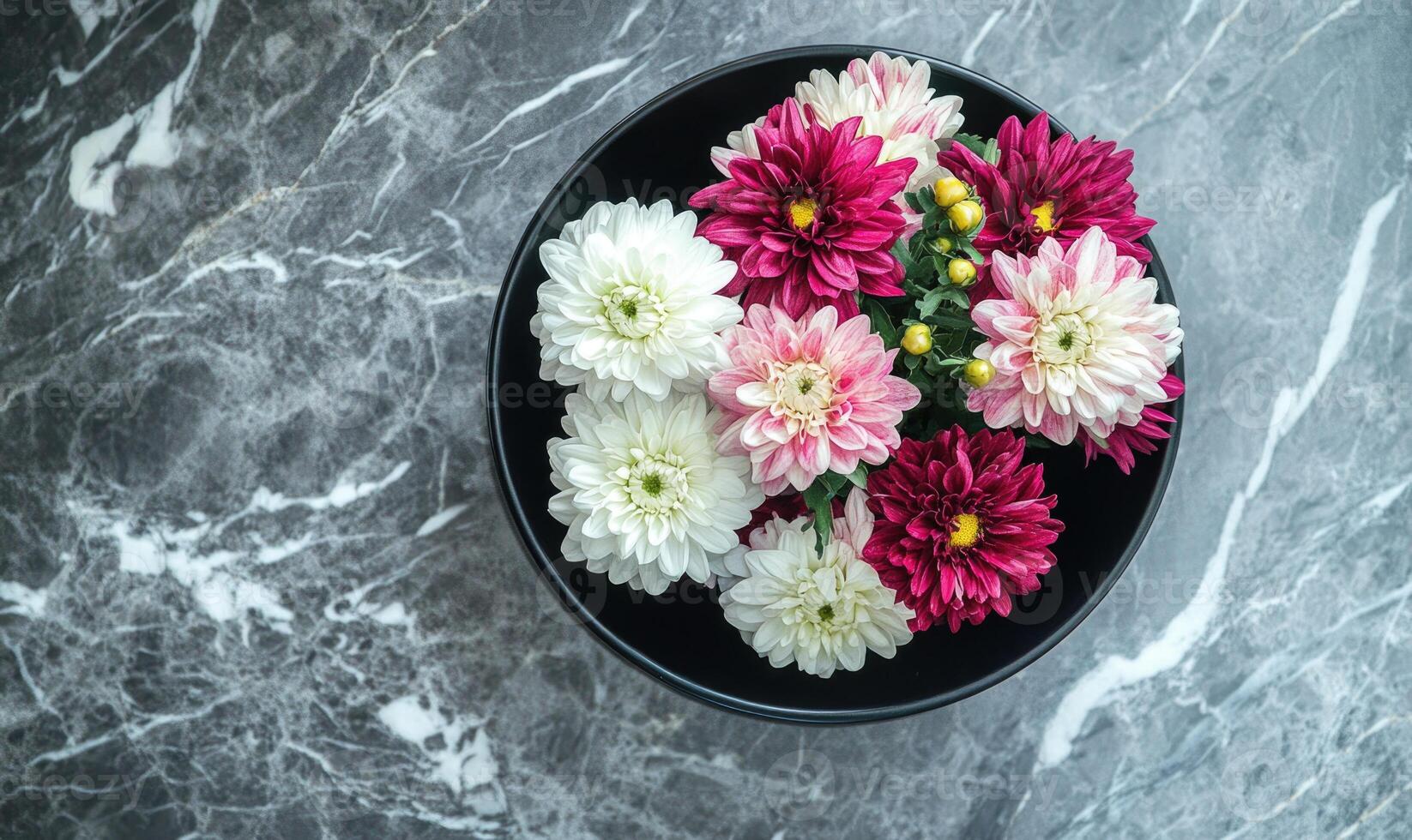 A bowl of flowers with white and pink flowers in it photo