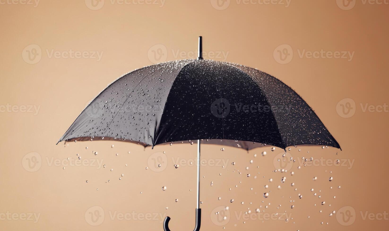A black umbrella is opened and raining on a wall photo