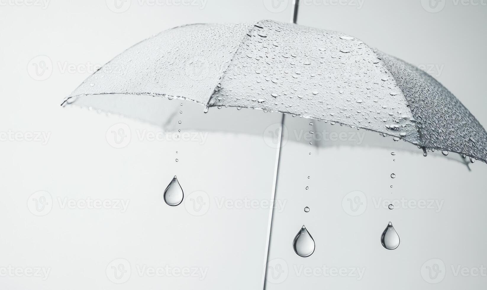 A white umbrella with three drops of water on it photo