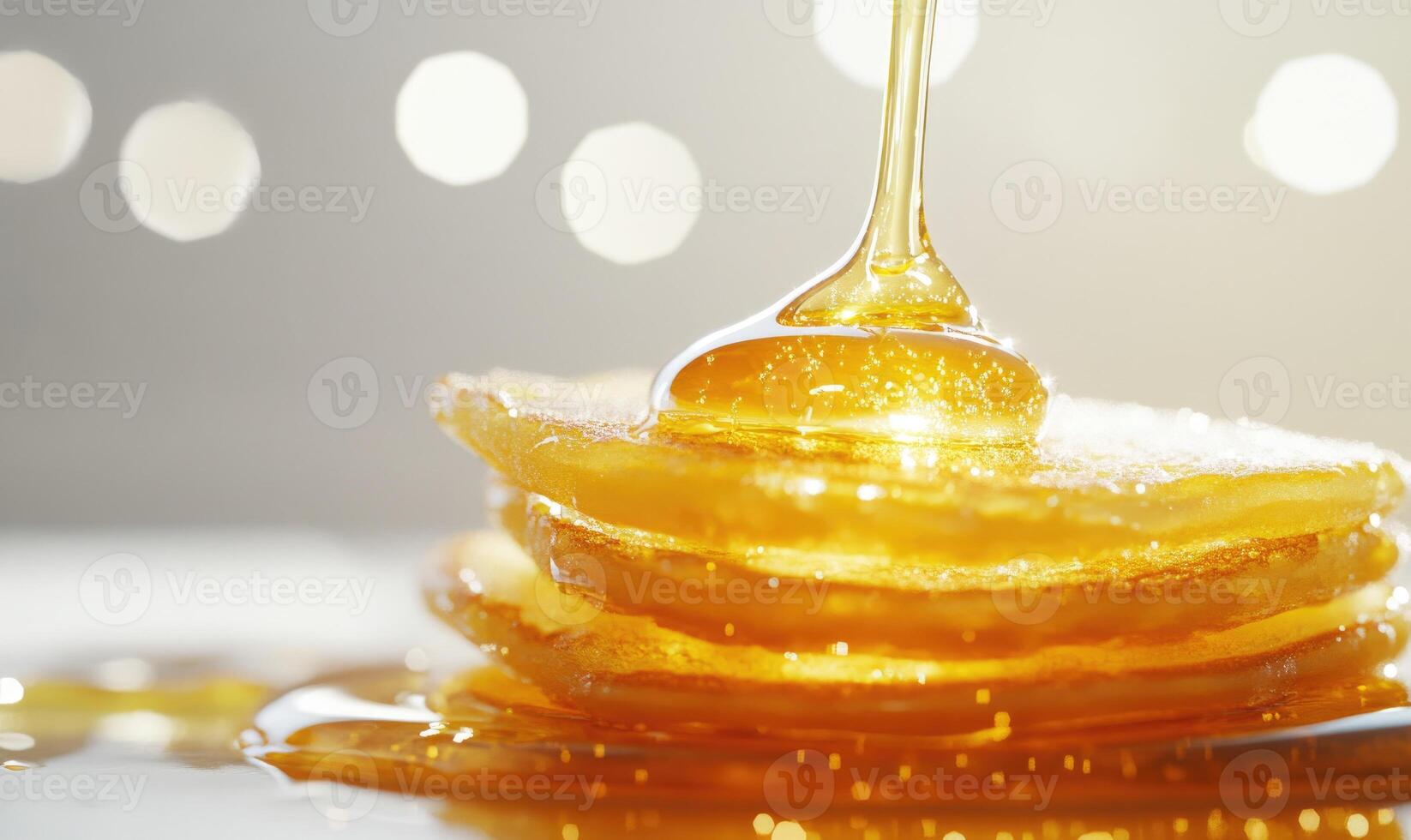 A stack of pancakes with a drizzle of honey on top photo