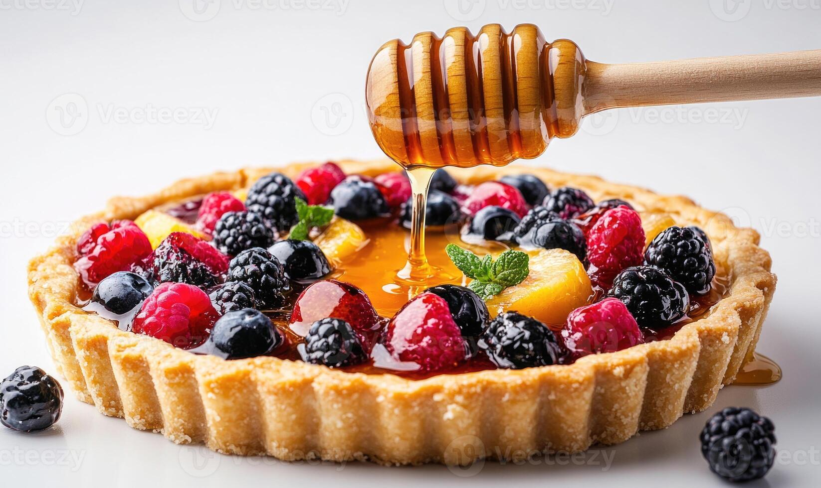 A dessert with a honey drizzle and berries on top photo