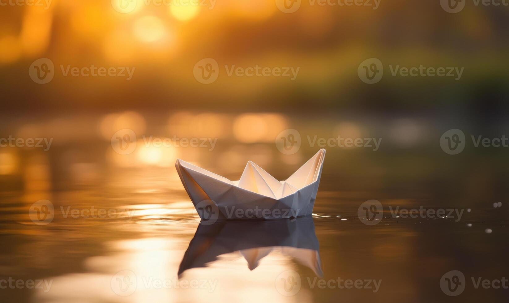 A paper boat is floating on the water, sunset light photo