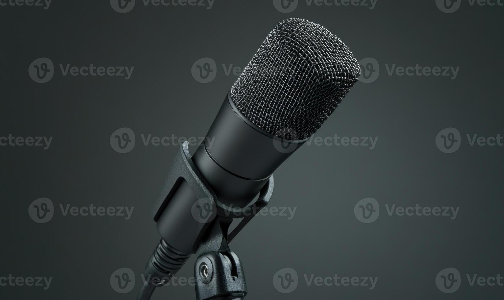 A microphone with a black plastic headpiece and a black cord photo