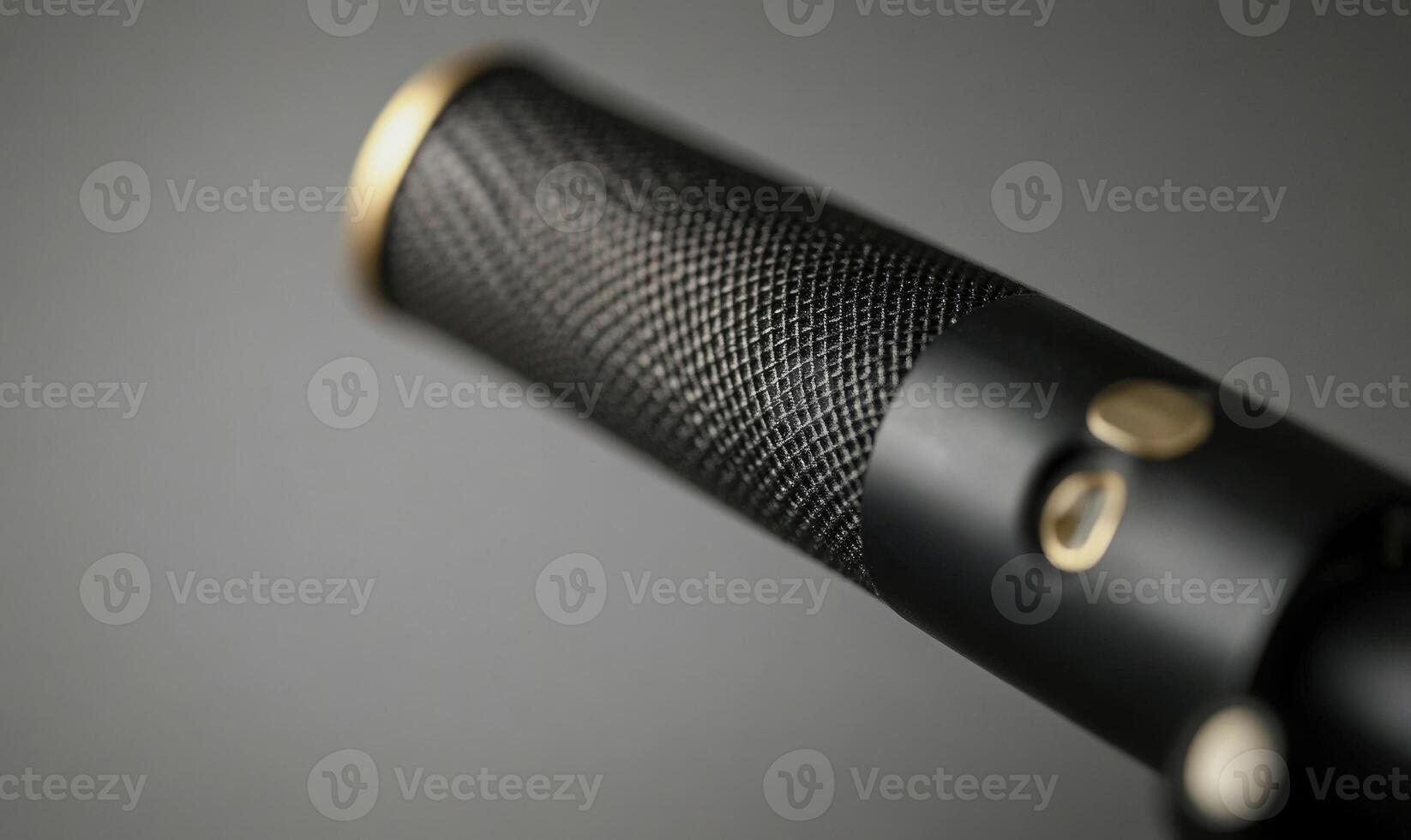 A microphone with a gold and black design photo
