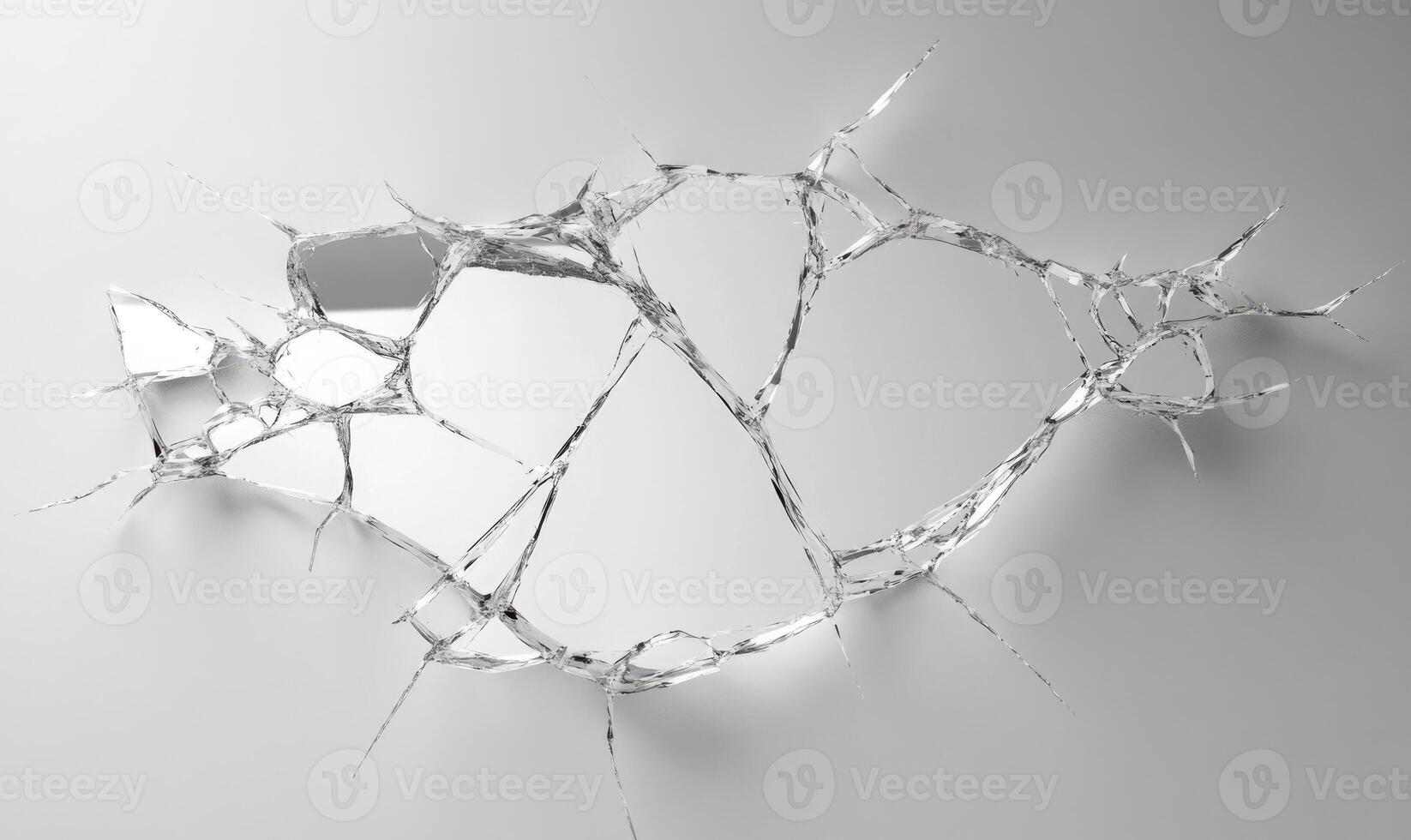A shattered glass window with a spider web pattern photo
