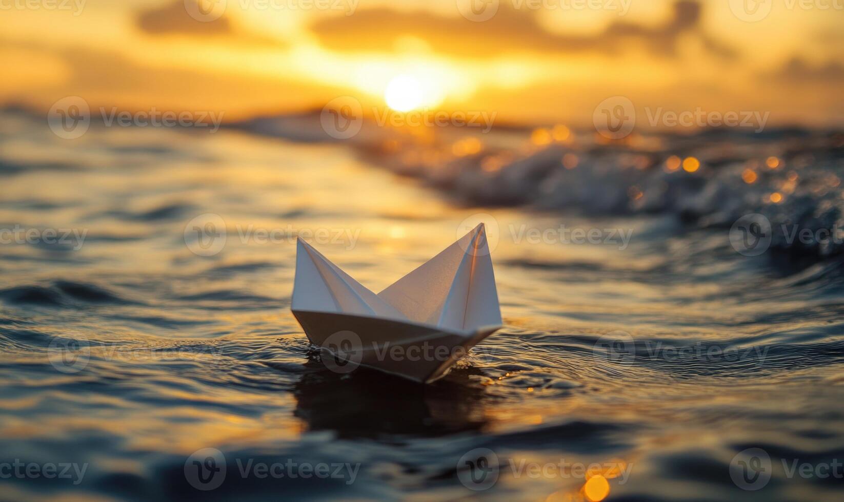 A paper boat is floating in the ocean photo