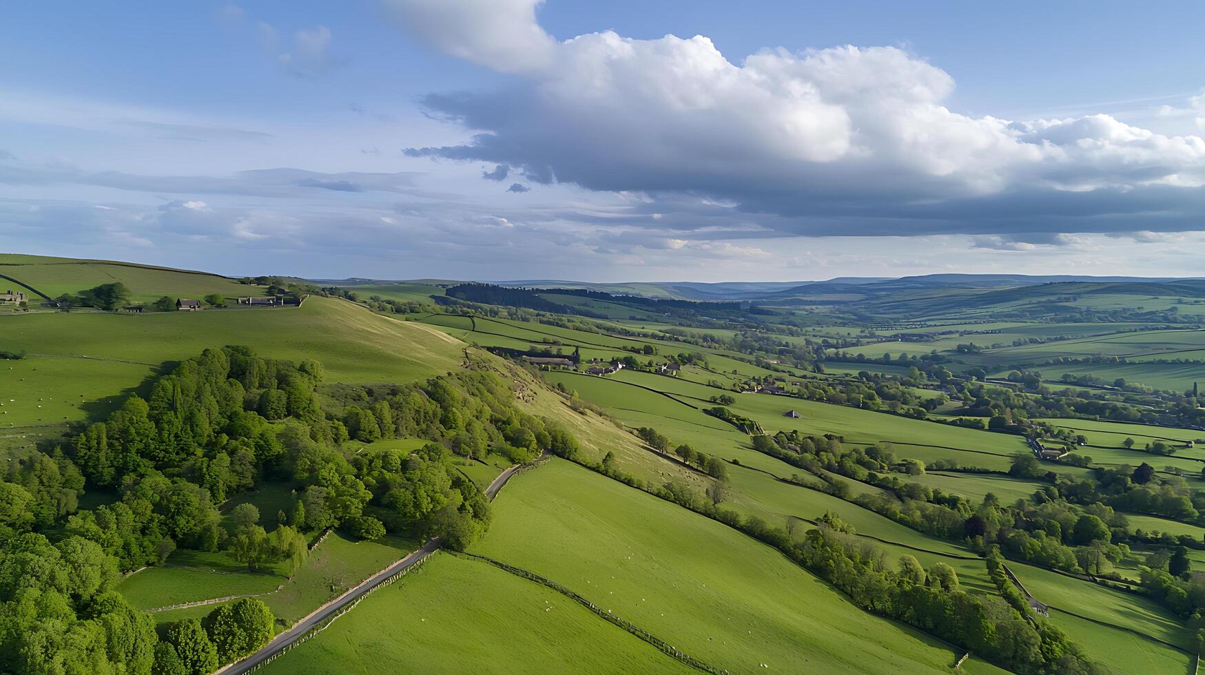 Aerial View of Rolling Green Hills and Farmland Under a Cloudy Sky. photo