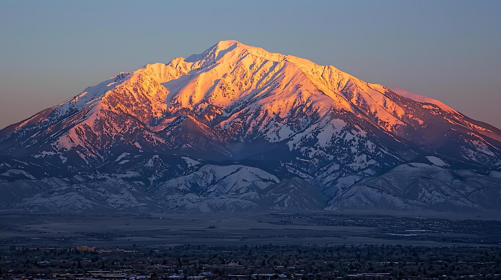 Majestic Sunset over a Snow-Capped Mountain Range. A breathtaking view of a dramatic alpine landscape at golden hour. photo