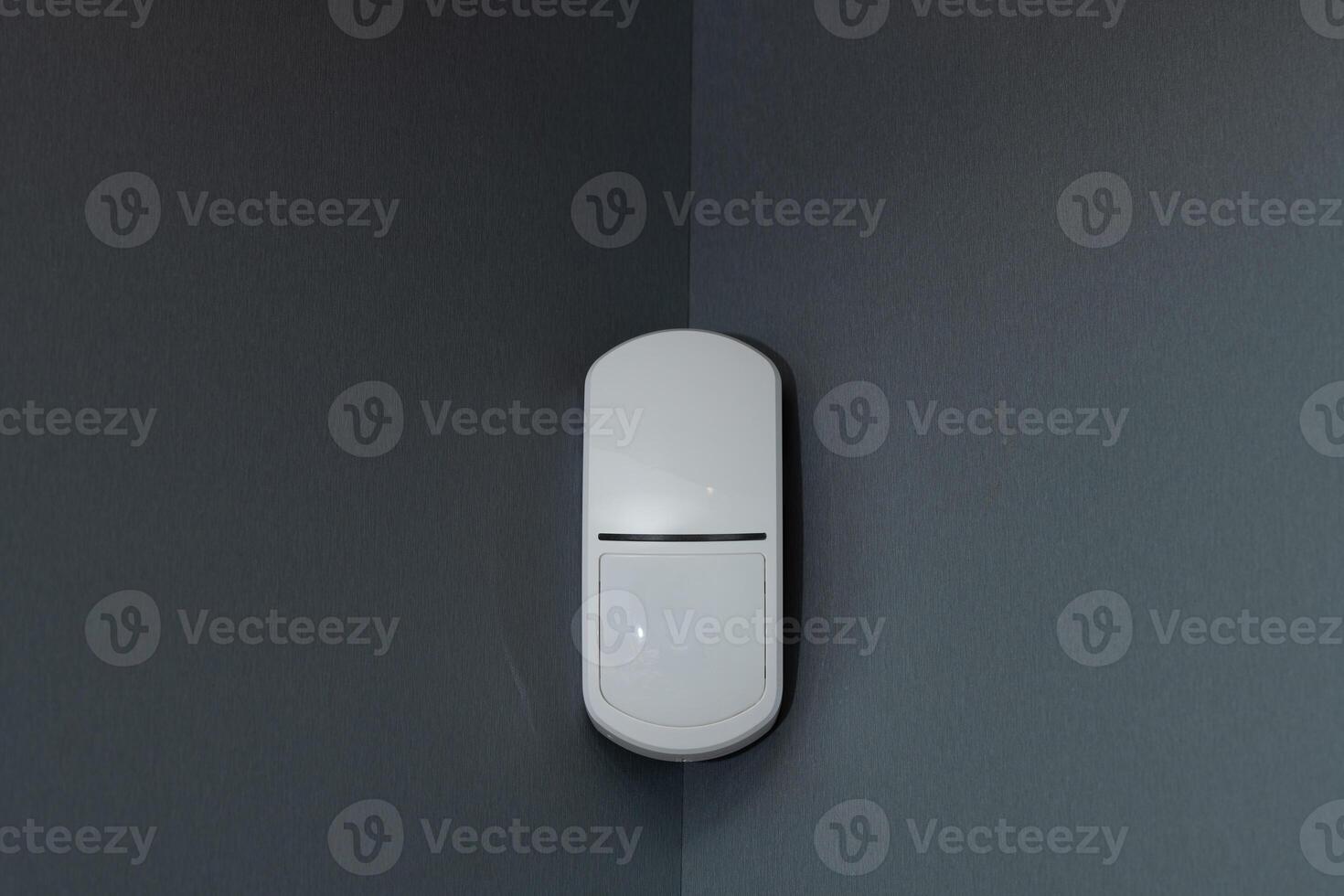 combined radar and passive infrared sensor on a gray wall. photo