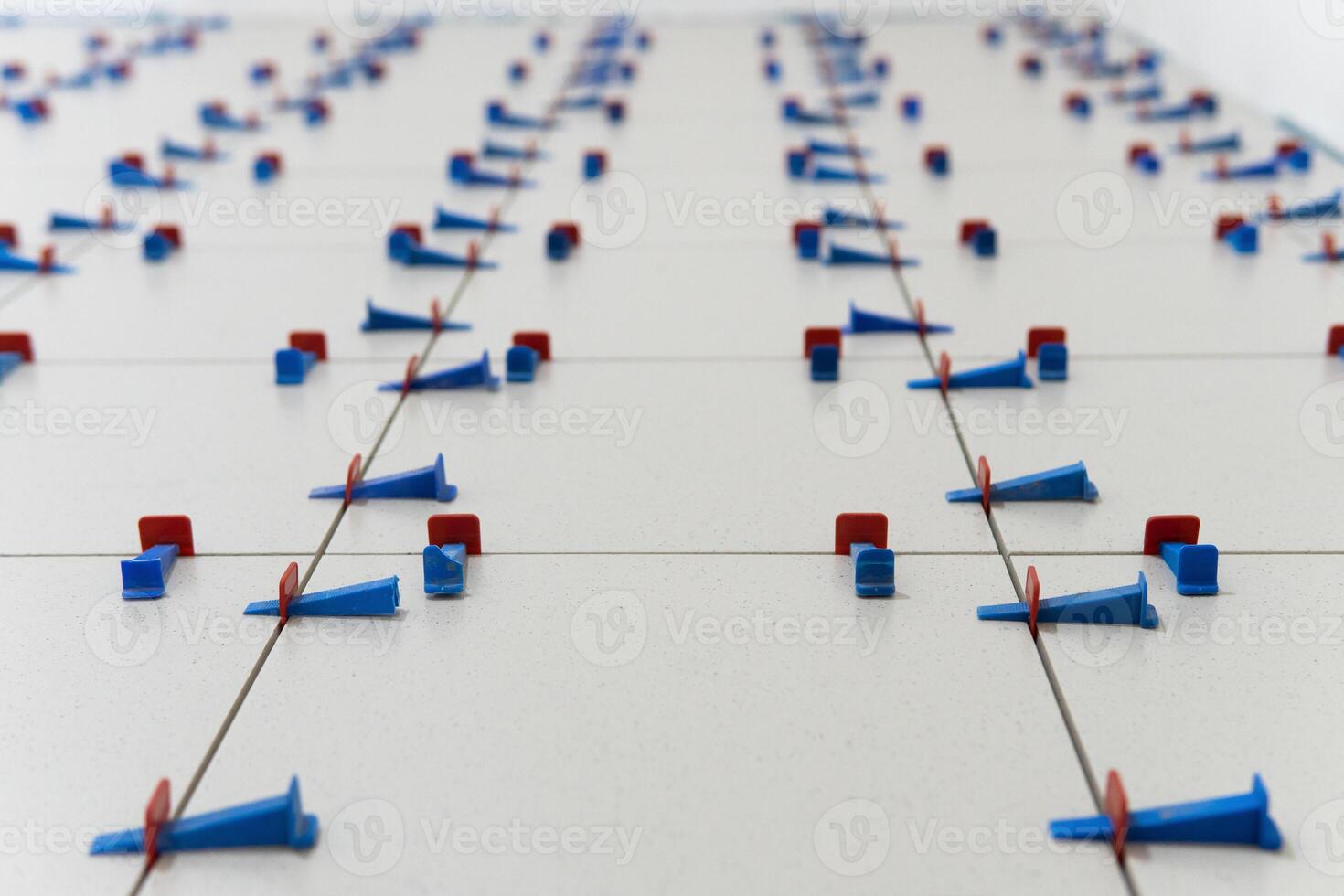Installing ceramic floor tile in new construction work by tile glue for good adhesion photo