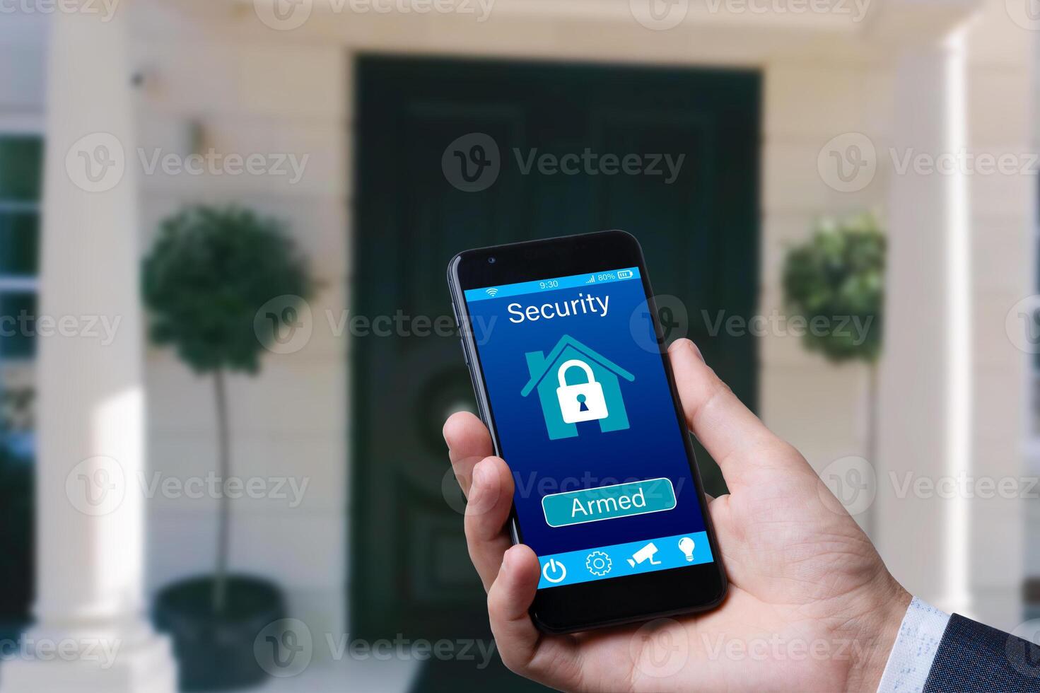 man controls smart home devices using app for mobile phone on background of the front door. concept of digitalization. a mockup with hand holding phone. photo