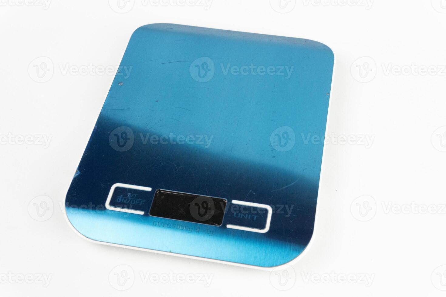 A top-down view of a blue digital kitchen scale on a clean white background, ready for measuring ingredients. photo