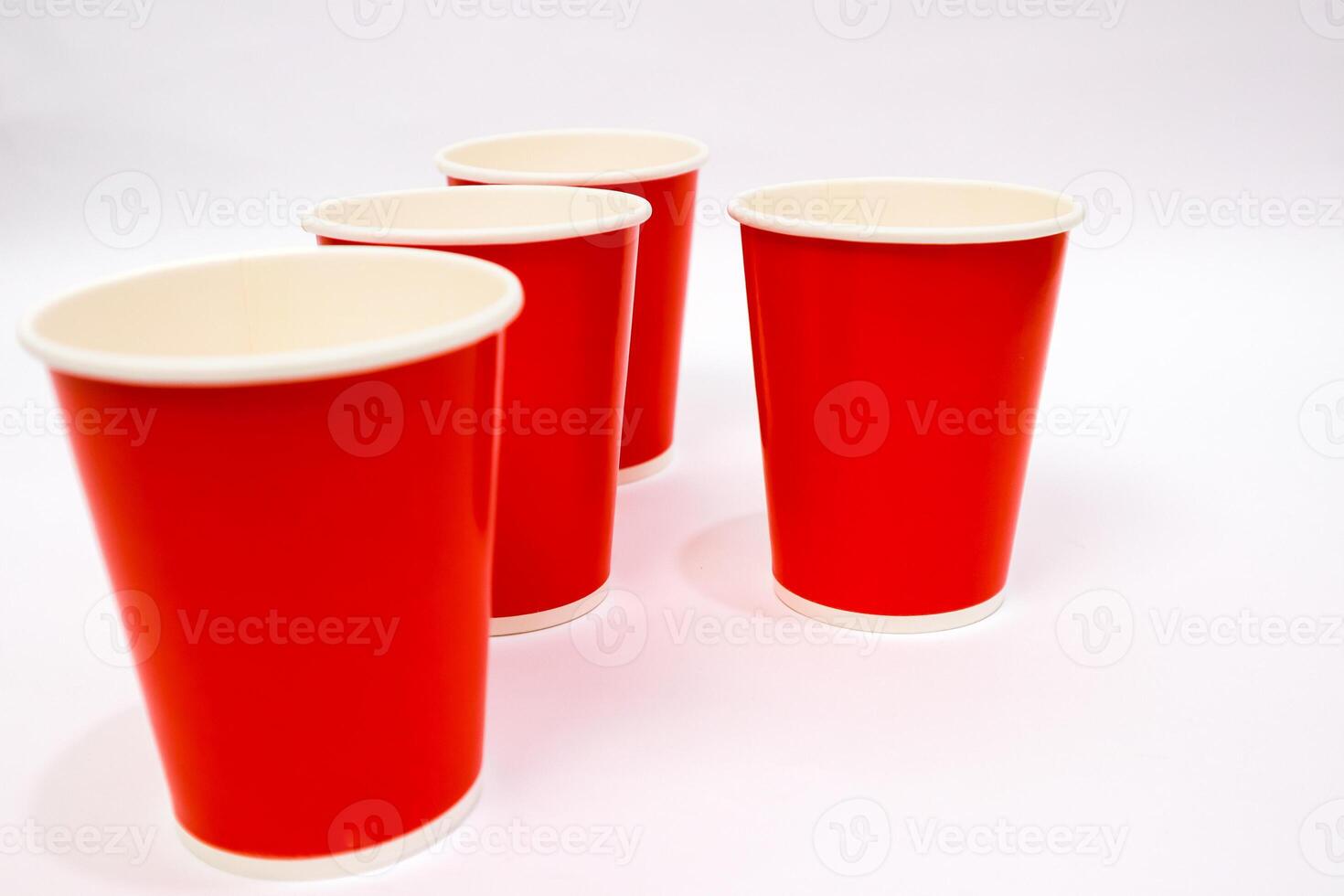 Vibrant Red Paper Cups Arranged on White Background Ready for Refreshments photo