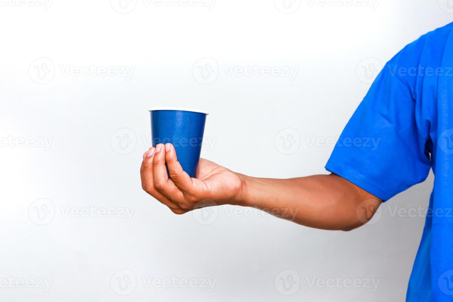 A Man's Hand Holding a Blue Cup in a White Background with a Blue Shirt photo