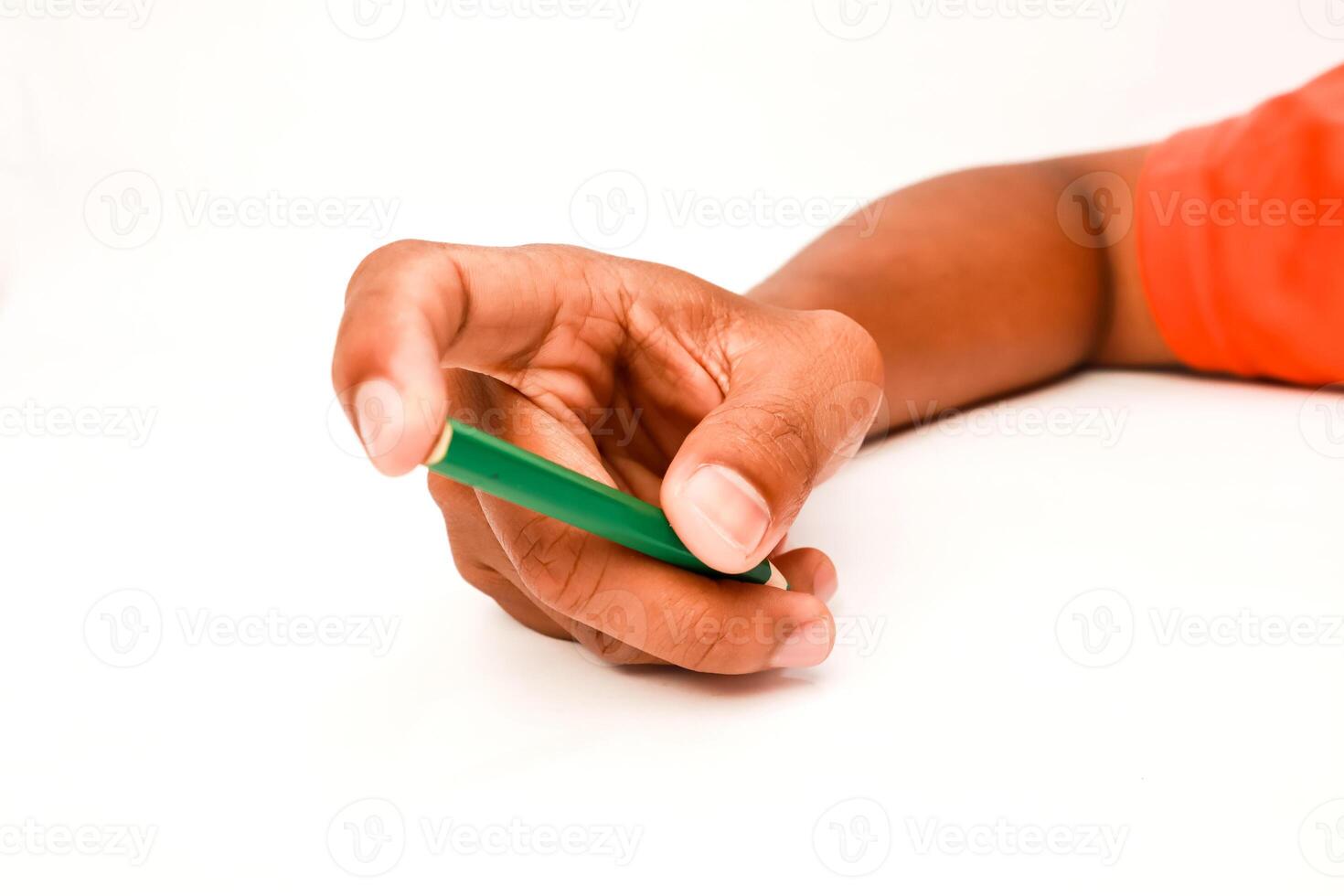 Hand holding green pencil on white background, writing or drawing concept, isolated shot for creative projects photo