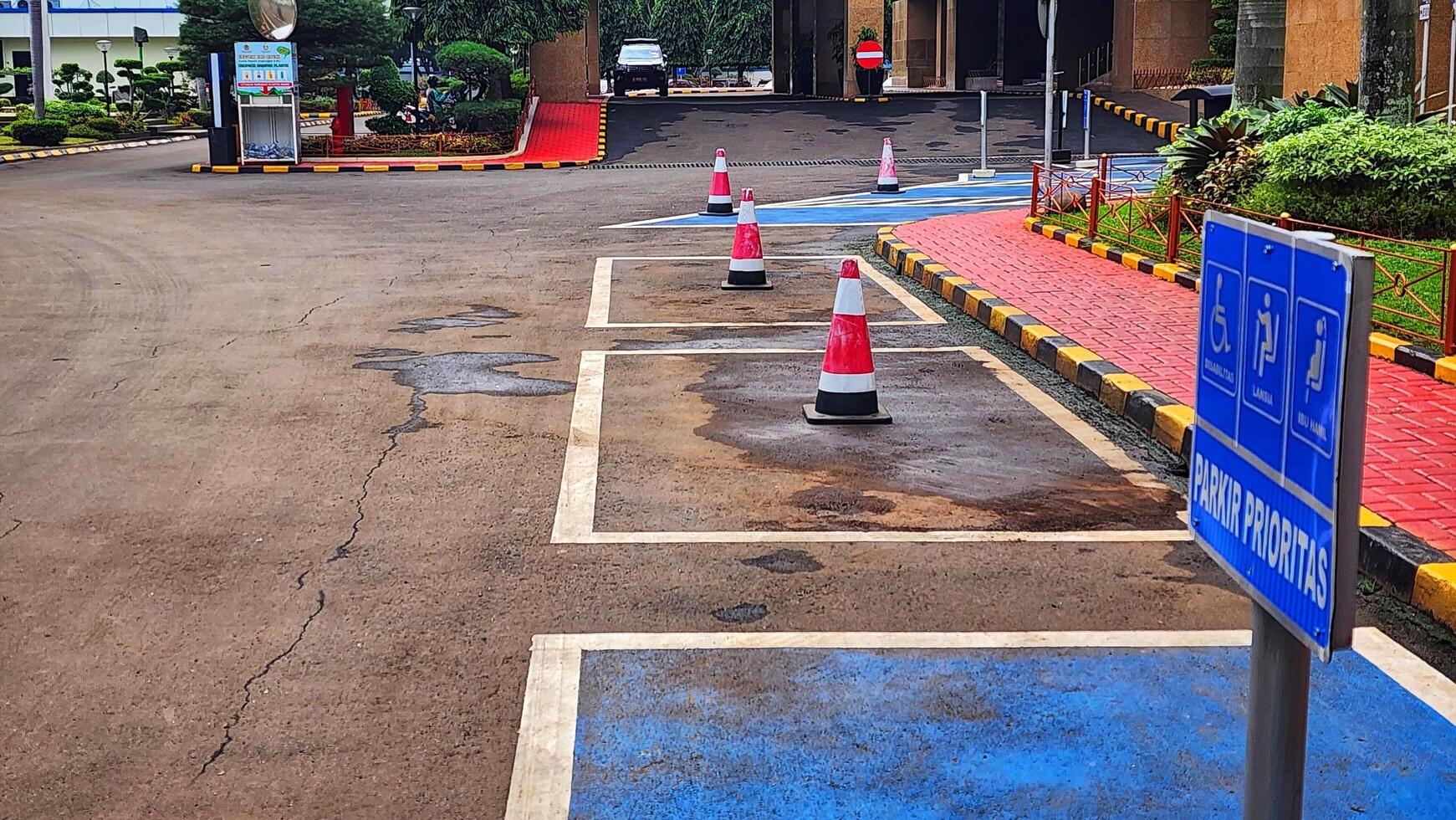 Jakarta, Indonesia. 23 April 2025. Designated Priority Parking Spots with Cones and Sign photo