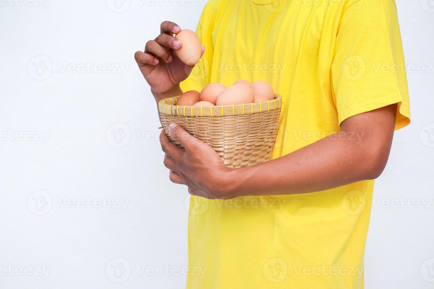 a man holding a basket of eggs photo