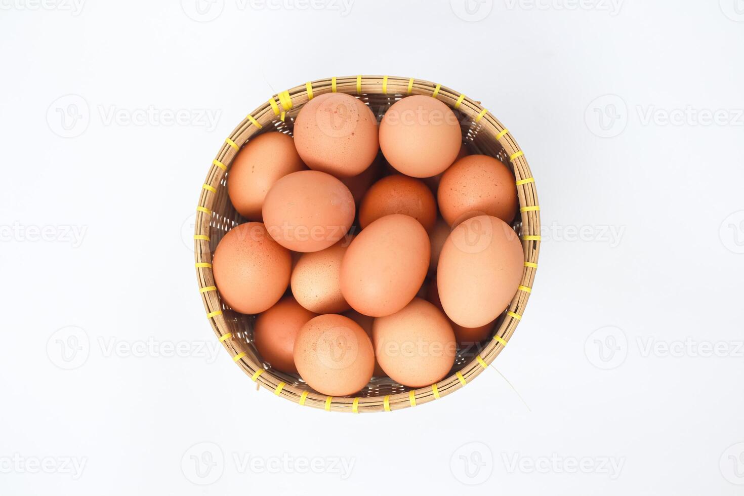 Light Brown Chicken Eggs In A Basket On White photo