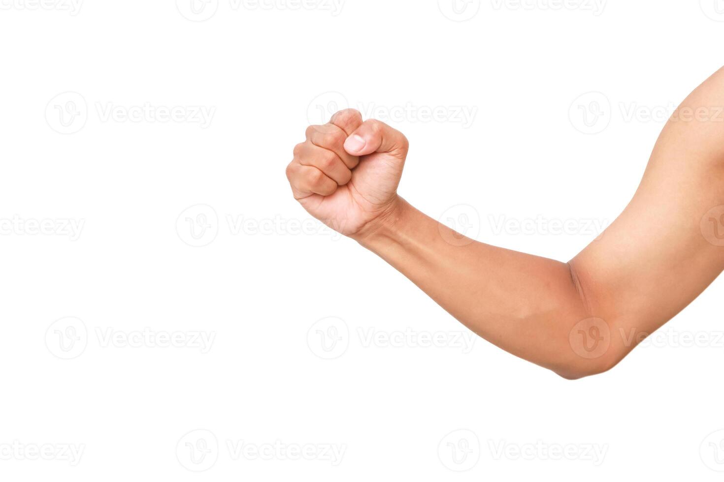 A clenched fist and forearm illustrate determination and strength on white background photo