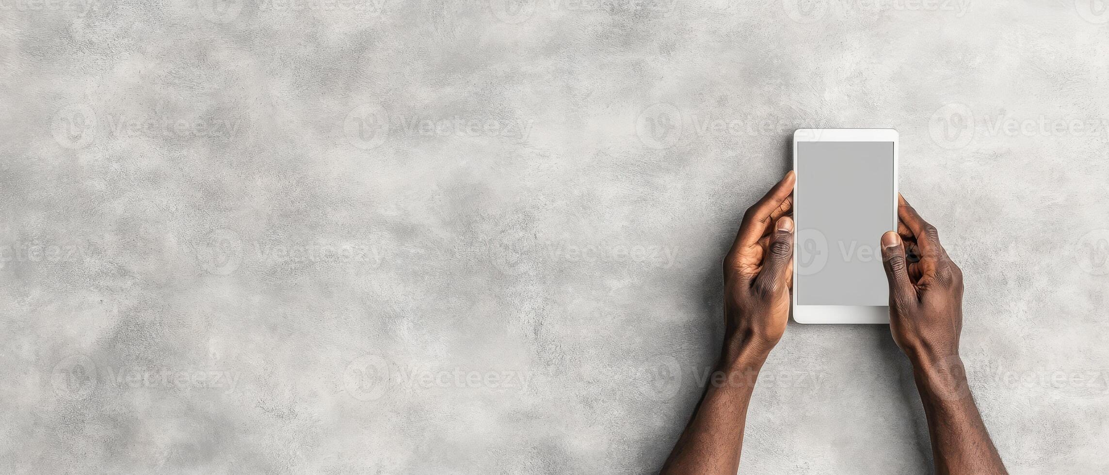 Hands holding tablet device. Cybersecurity awareness concept. White blank screen display. Concrete background. Digital technology secure network photo