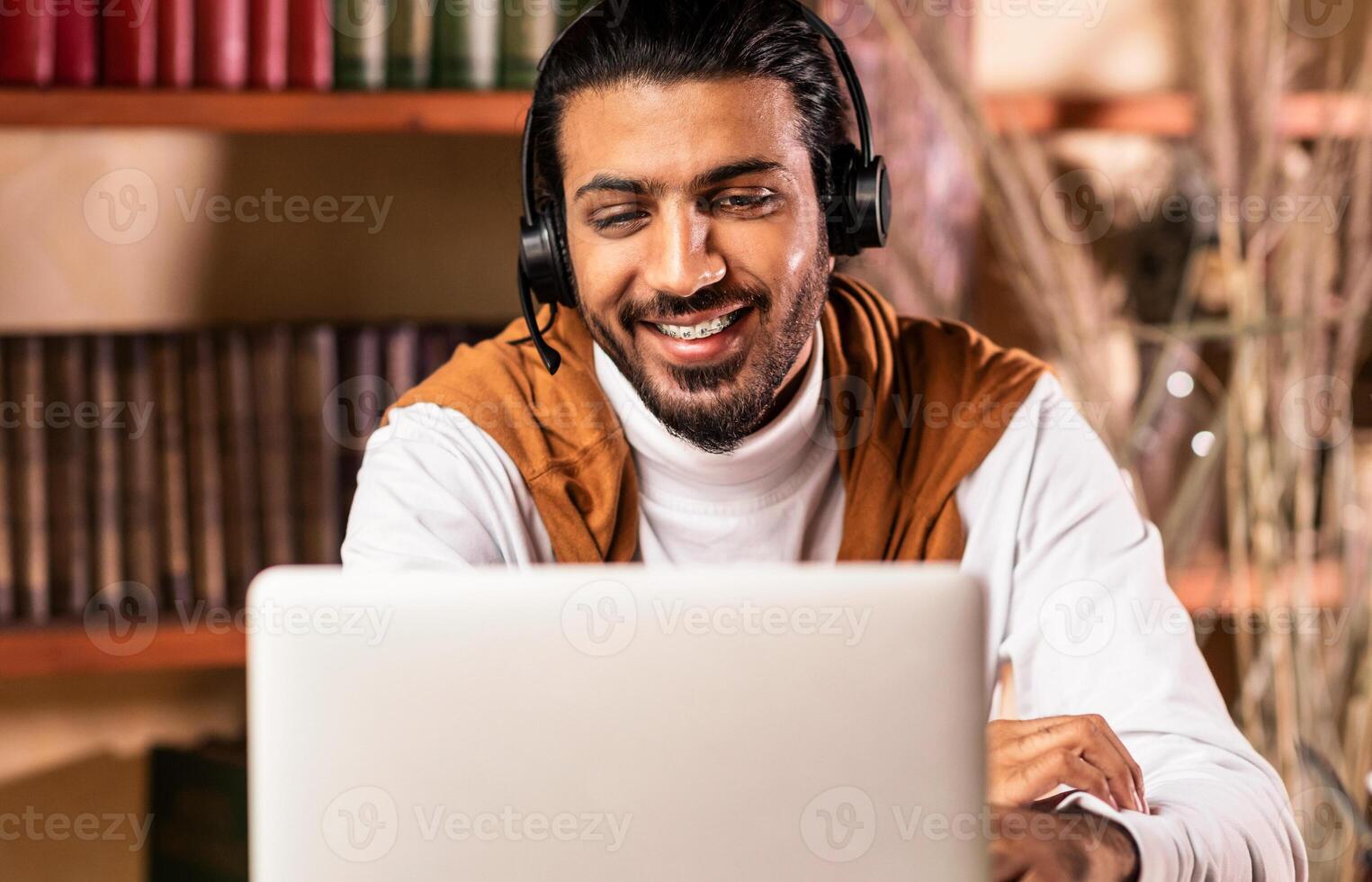 Cheerful Indian Teacher Having Online Class Making Call Via Laptop Computer Teaching Talking With Student, Explaining Lesson Sitting At Home. Remote Education, E-Learning And Teaching Concept photo