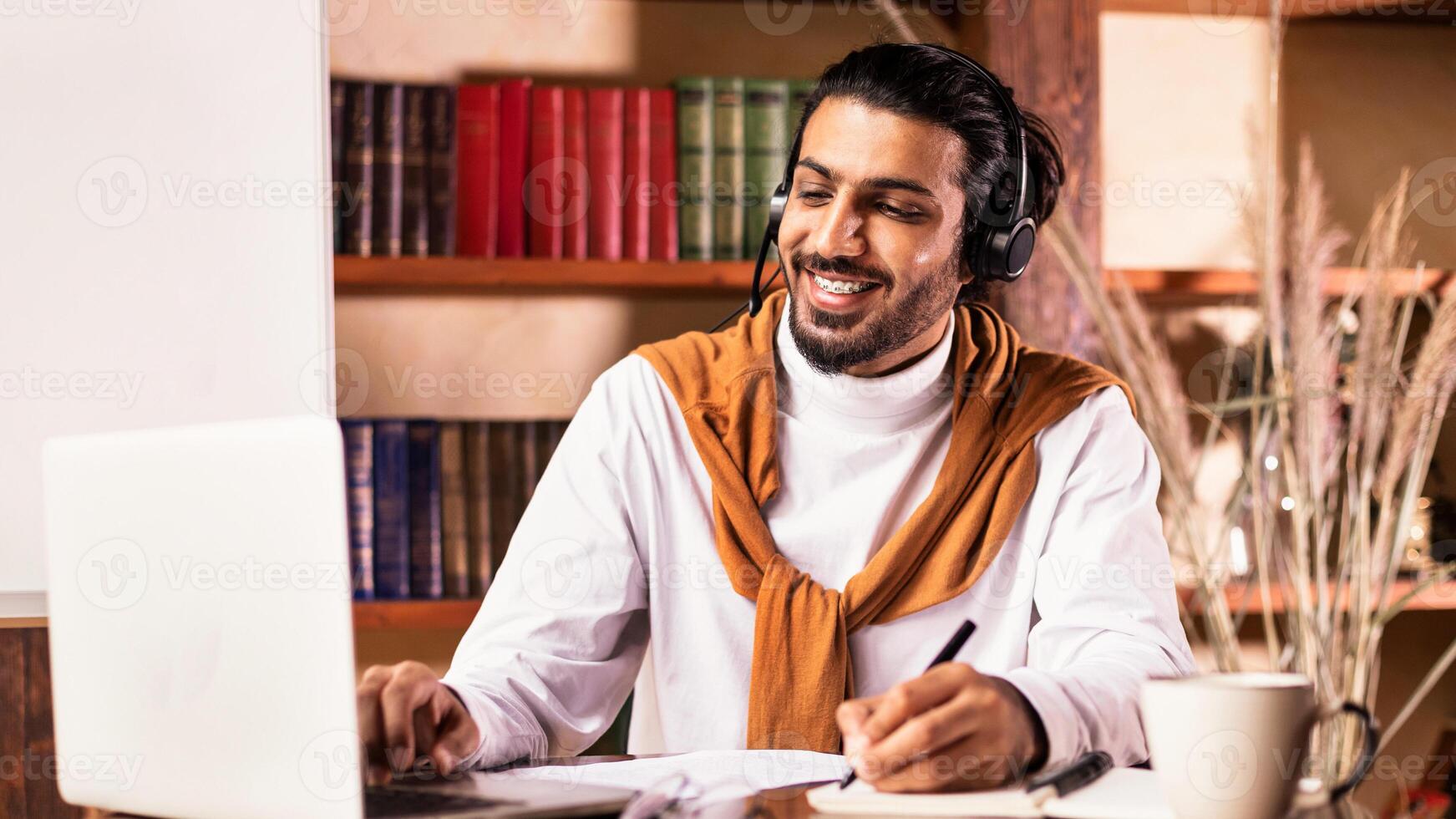Cheerful Indian Teacher At Laptop Computer Teaching Online Having Remote Class With Distant Student Sitting Indoors, Working From Home. Modern Education And Tutoring, E-Teaching Training Concept photo