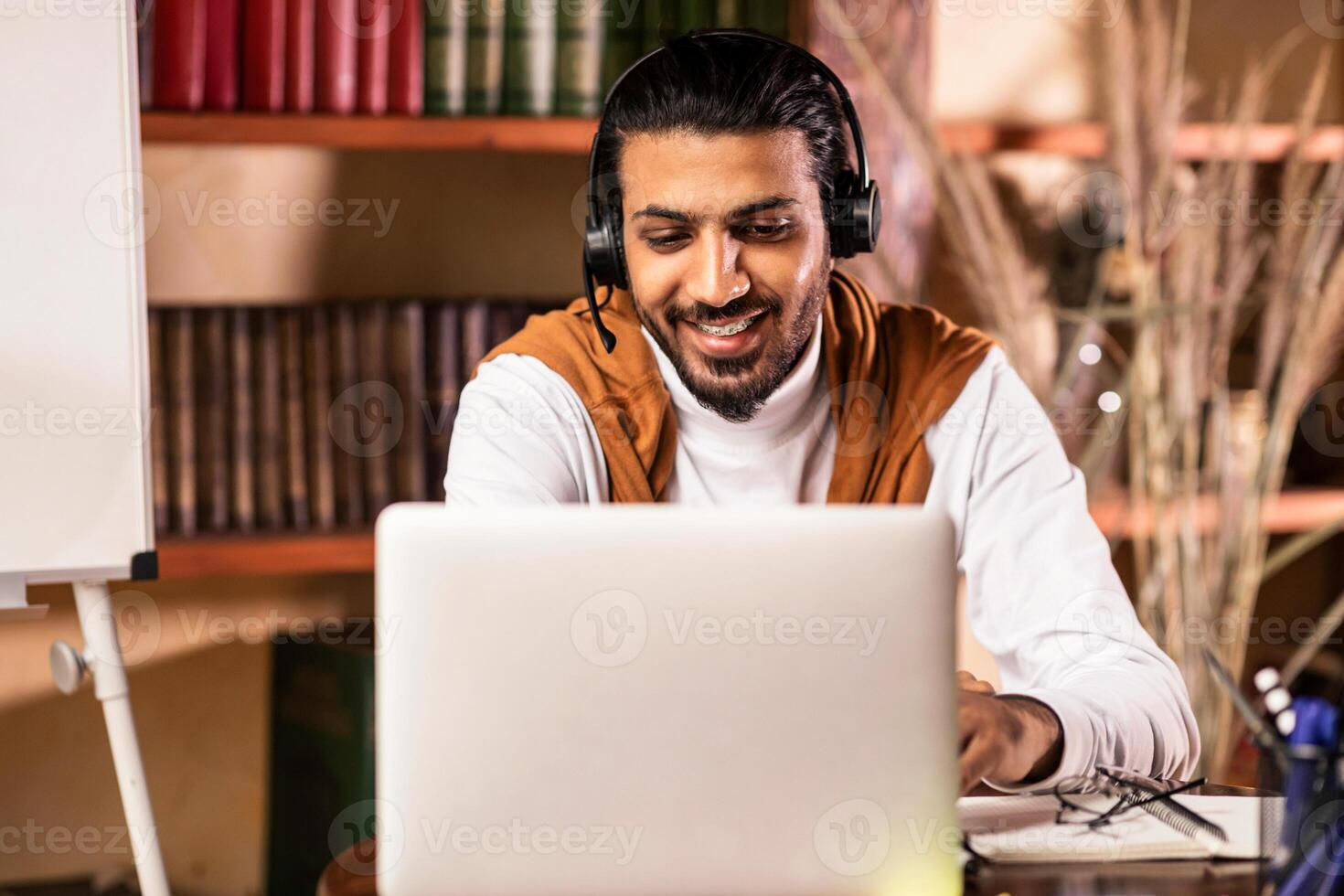 Online Lecture. Tutor Man Having Class Via Call On Laptop Wearing Headphones Teaching Remote Students Indoors. E-Teaching And Distance Education, Online Tutoring. Selective Focus photo