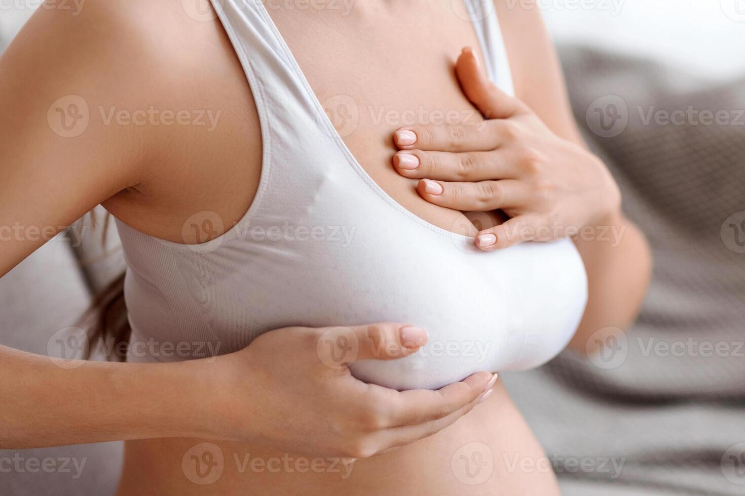 Breast Massage. Unrecognizable Pregnant Woman In Bra Massaging Her Chest At Home, Expectant Mother Having Painful Feelings During Pregnancy, Self-Testing Herself, Cropped Image, Closeup photo